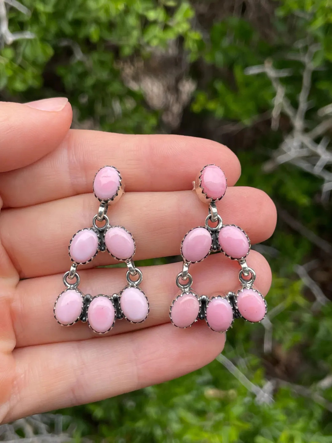 DescriptionThese handcrafted earrings feature soft pink conch stones arranged in a graceful chand... | Etsy (US)