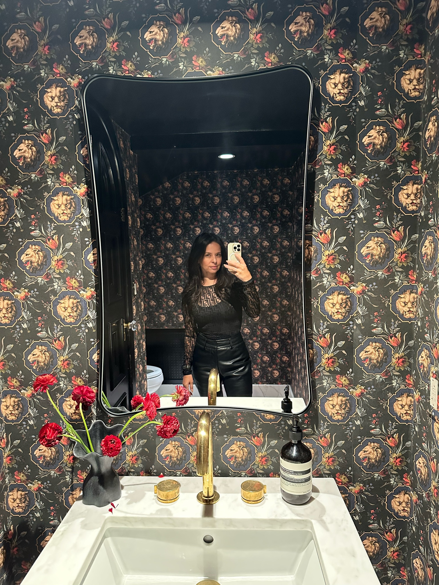 Gucci wallpaper in powder room 
Simple black vase w/ fresh flowers
Hand soap
Brass gold faucet
Deluxe mirror for wall
Faux leather pants
Fendi bodysuit


#LTKHome #LTKParties #LTKStyleTip