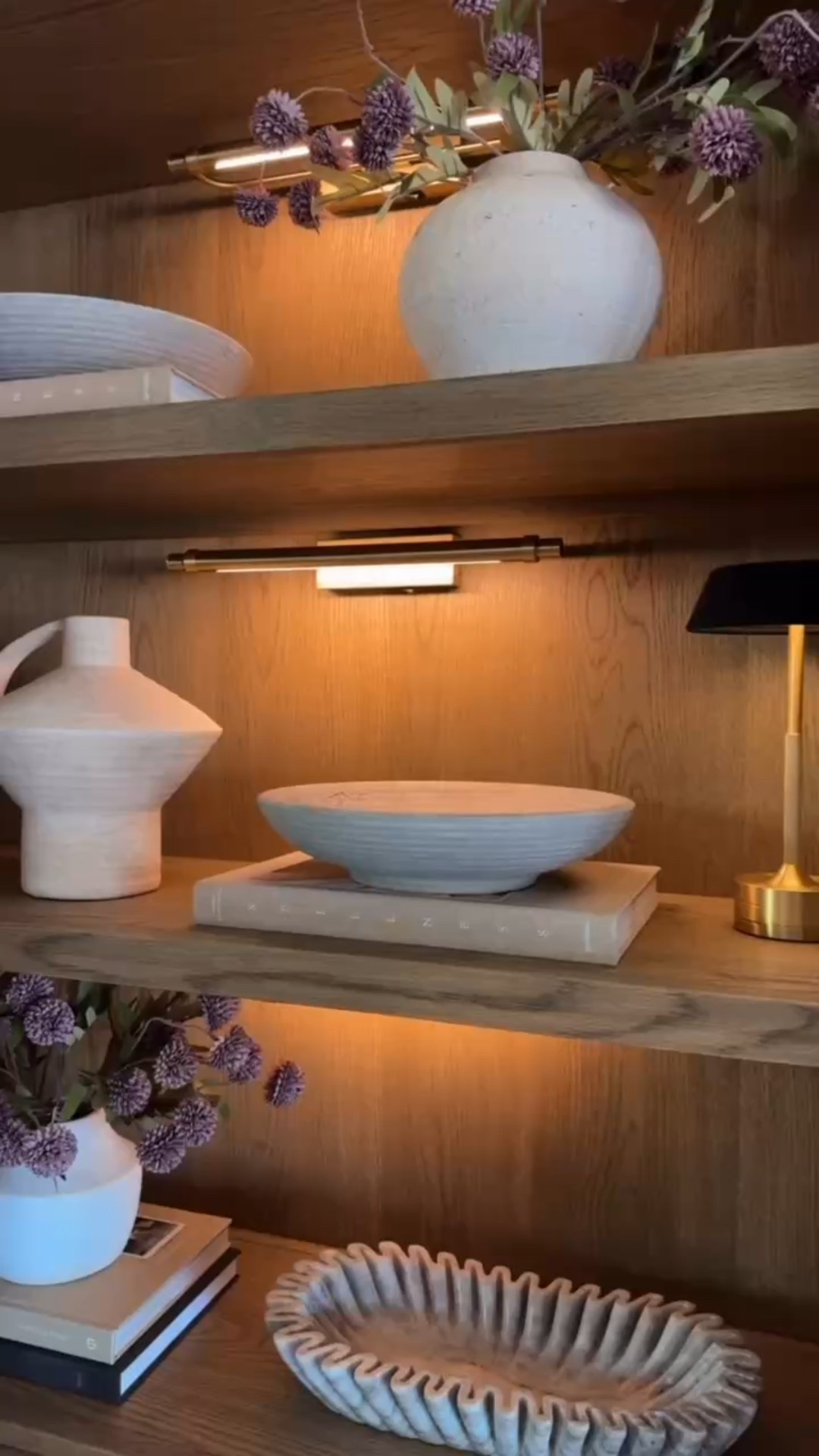 Shelf styling is always a favorite of mine! 

Gallery lighting. Ceramic. Vase. Bowl. Accent lamp. Accent lighting. Faux stems. Vase. Neutral home. Coffee table books. Modern home decor accents  