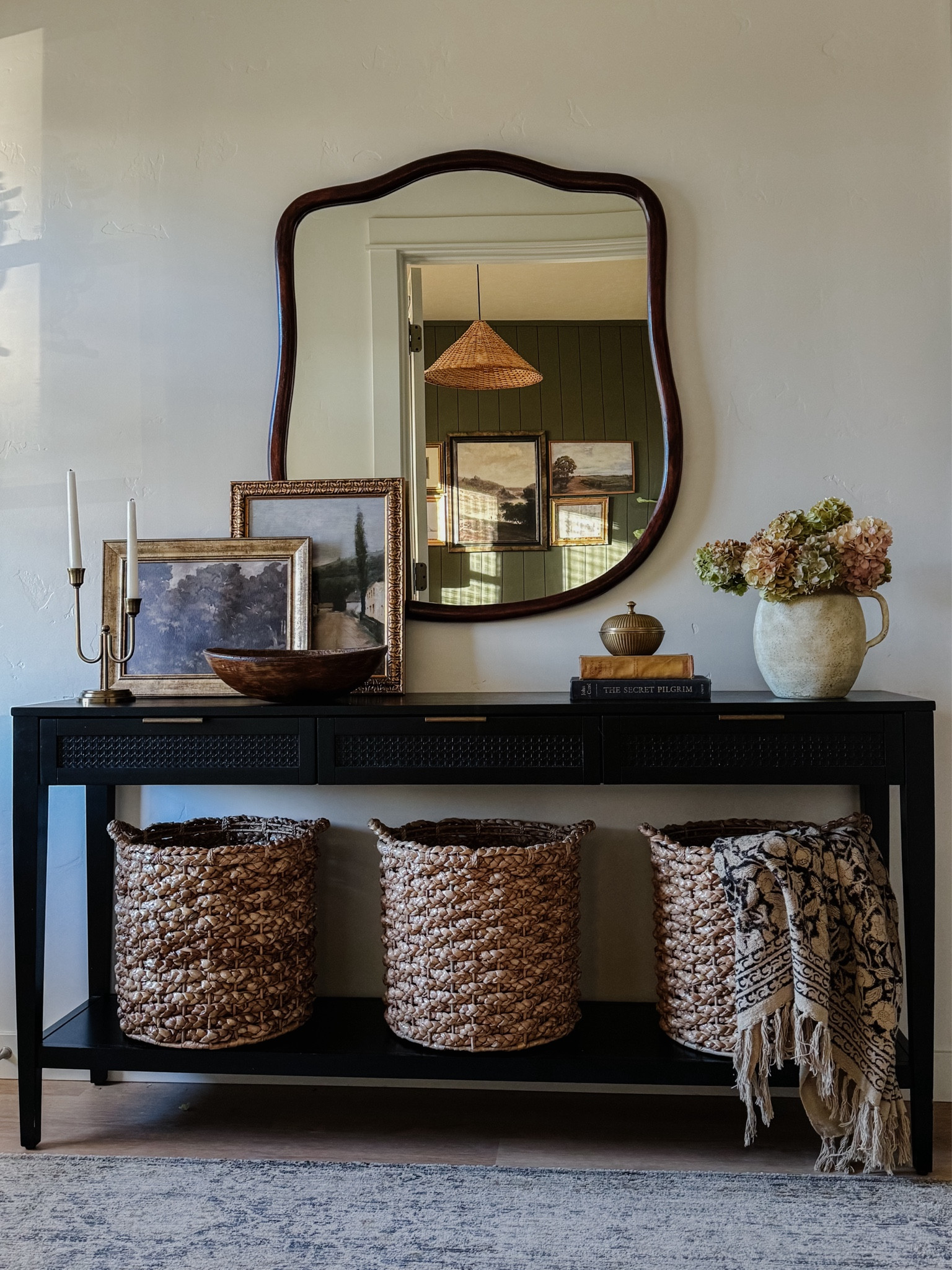 Entryway inspiration, console table styling, home decor, transitional style, organic modern, black console table, paper mache bowl, brass candlesticks, large wicker basket, vintage throw, rattan conical lamp shade, antique inspired large mirror, minka pot, modern mirror, large mirror, Loloi rug, transitional design, low pile rug, wall art, collected look

#LTKSummerSales #LTKStyleTip #LTKHome