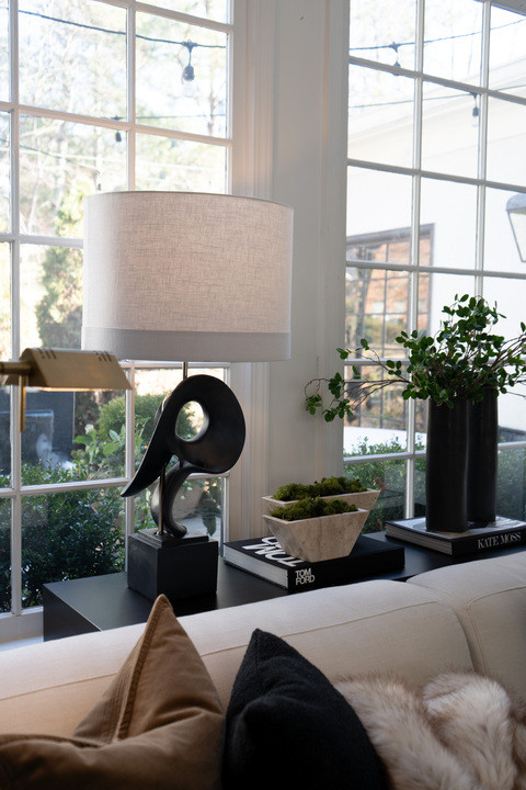OMG this cozy living room corner came together perfectly!! Neutral sofa styling, layered pillows, modern sculptural lamp, coffee table books and greenery giving major designer home vibes. The natural light pouring through the windows makes this space feel bright, airy, calm and seriously high end. I keep walking by just to look again! 

 #LTKSeasonal #LTKHome #LTKSaleAlert