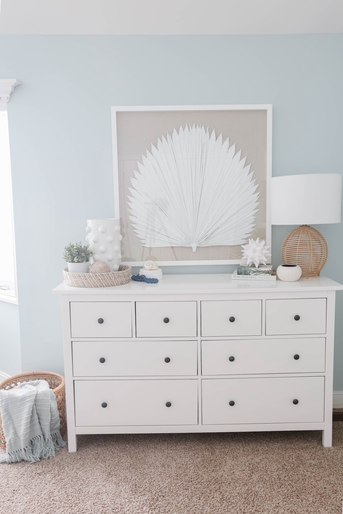 This blue bedroom with a white dresser, palm leaf artwork, and layered coastal decor is one of my favorite modern coastal spaces. I love how the blue walls paired with crisp white furniture and beachy accents make the room feel calm, bright, and designer-inspired. 

#LTKHome #LTKU #LTKSaleAlert