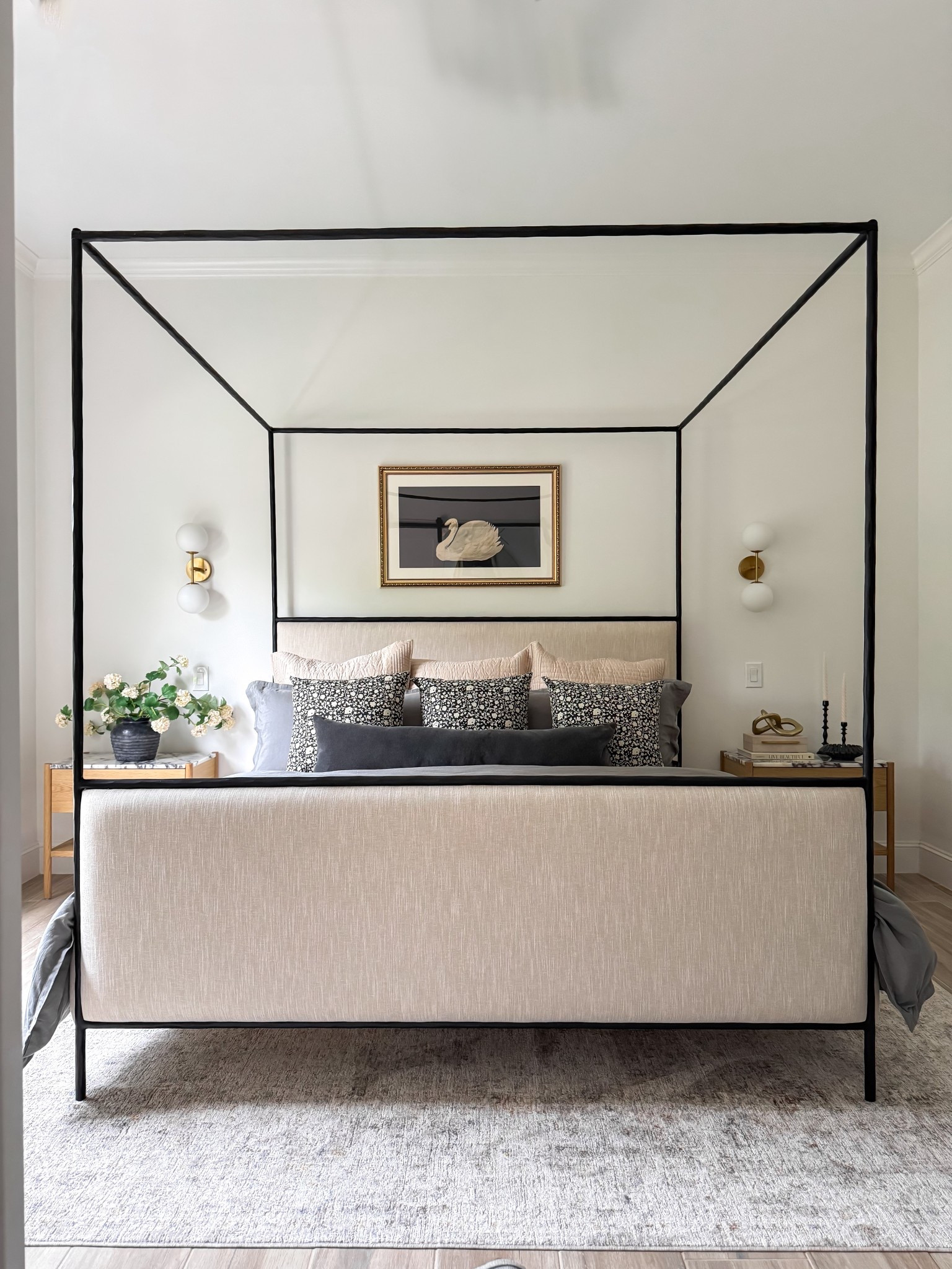 Our guest room is ready for its first guests! I have eyed this Crate and Barrel bed for years and she doesn’t disappoint.  Super heavy, high quality and that gorgeous iron frame is scrumptious.  Sold out ATM so I linked a similar bed. 

I went with lux bedding from West Elm.  The end tables are Lulu & Georgia and there’s a matching dresser on the other side of the room.  Amazon affordable decor adds the perfect touches like this under $100 swan artwork - a nod to my Grandma who had pet swans on her river house.   The rug is my forever favorite neutral rug that can seriously go in every room from Loloi. 

I’m still deciding on whether to paint the room / ceiling or do an accent wall behind the bed.  What would you do? 

I had an electrician hard wire the sconces and add switches next to each side of the bed for guests to easily turn on them on.  They provide the perfect ambience! 

#LTKFindsUnder100 #LTKHome