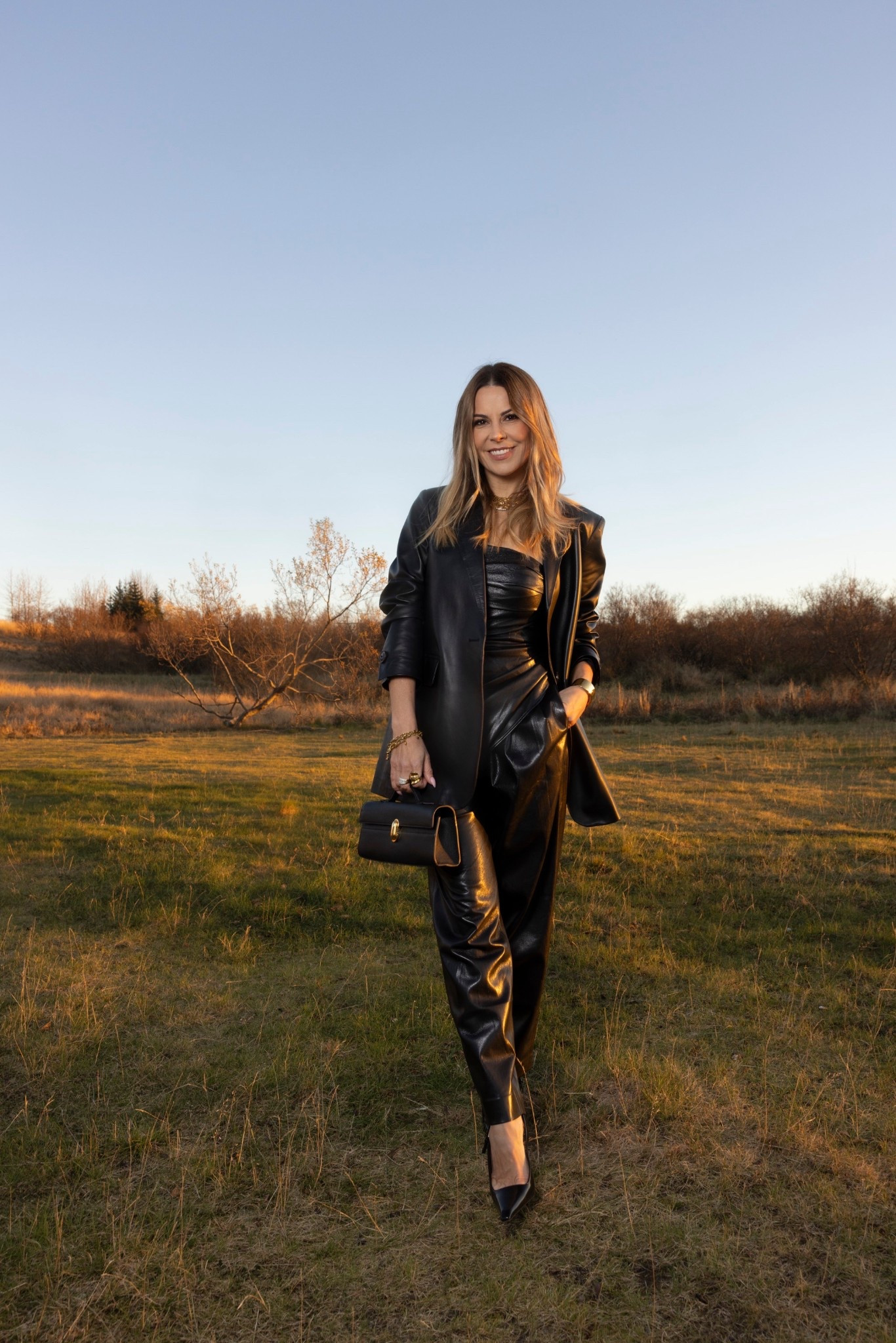 Leather blazer old, linked very similar one. I love a leather blazer. 

Jumpsuit in a size 40. It’s tight, the zipper broke, I replaced it. This jumpsuit is just so good for winter dinners. 

And I’m obsessed with this Savette bag. 