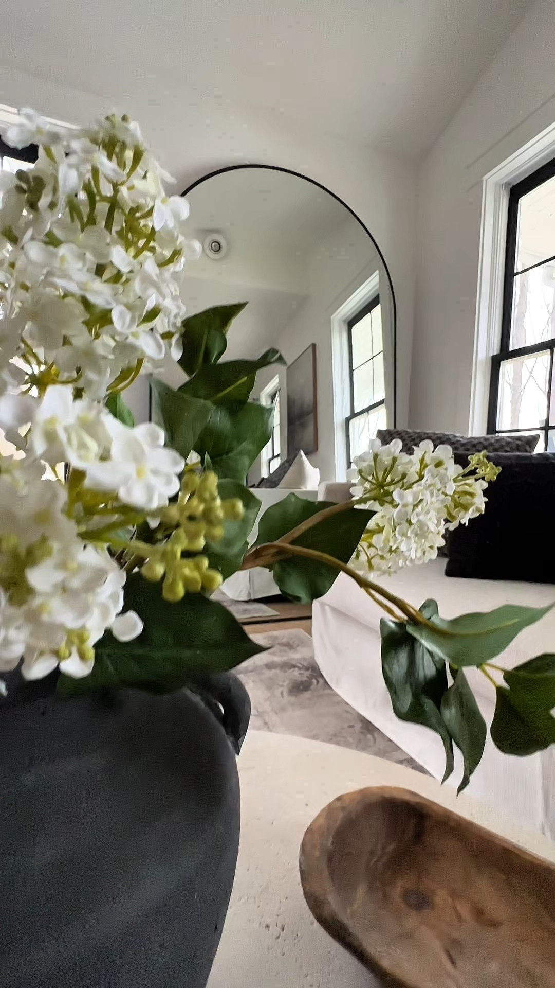 If you have a small room, try adding an oversized mirror. It reflects light and makes it appear so much larger. I put this in my living room and it adds so much light and depth. Pro tip: I saved hundreds on this mirror by getting it in an off color that was on sale and painting it black. I did the same with our new front door. 

🏷️ large mirror // coffee table // living room decor // arched mirror // faux flowers // coffee table styling 

#LTKHome #LTKStyleTip