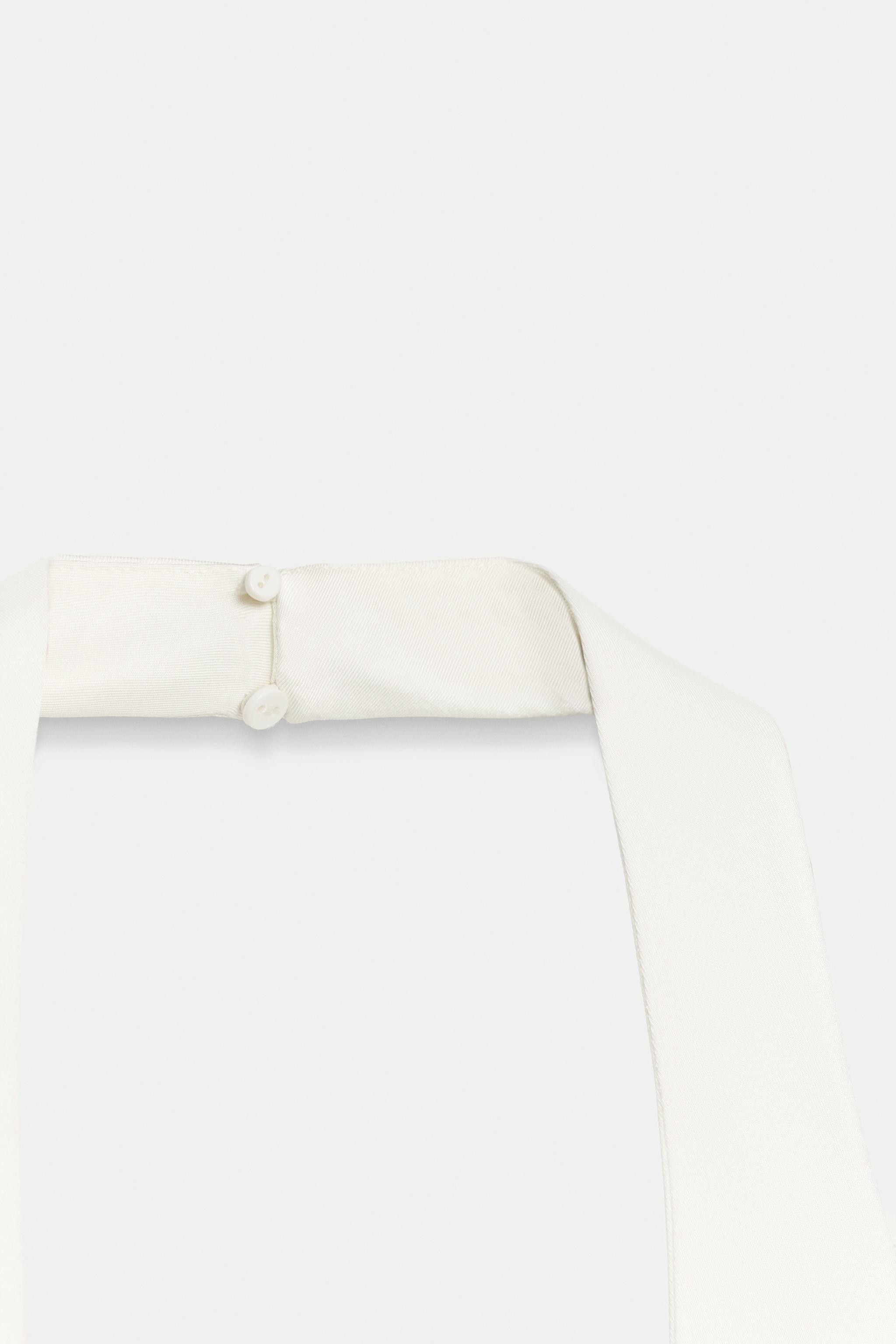 Model height: 181 cmV-neck top with an open back. Flared hem. Back fastening with hidden buttons ... | Zara UK