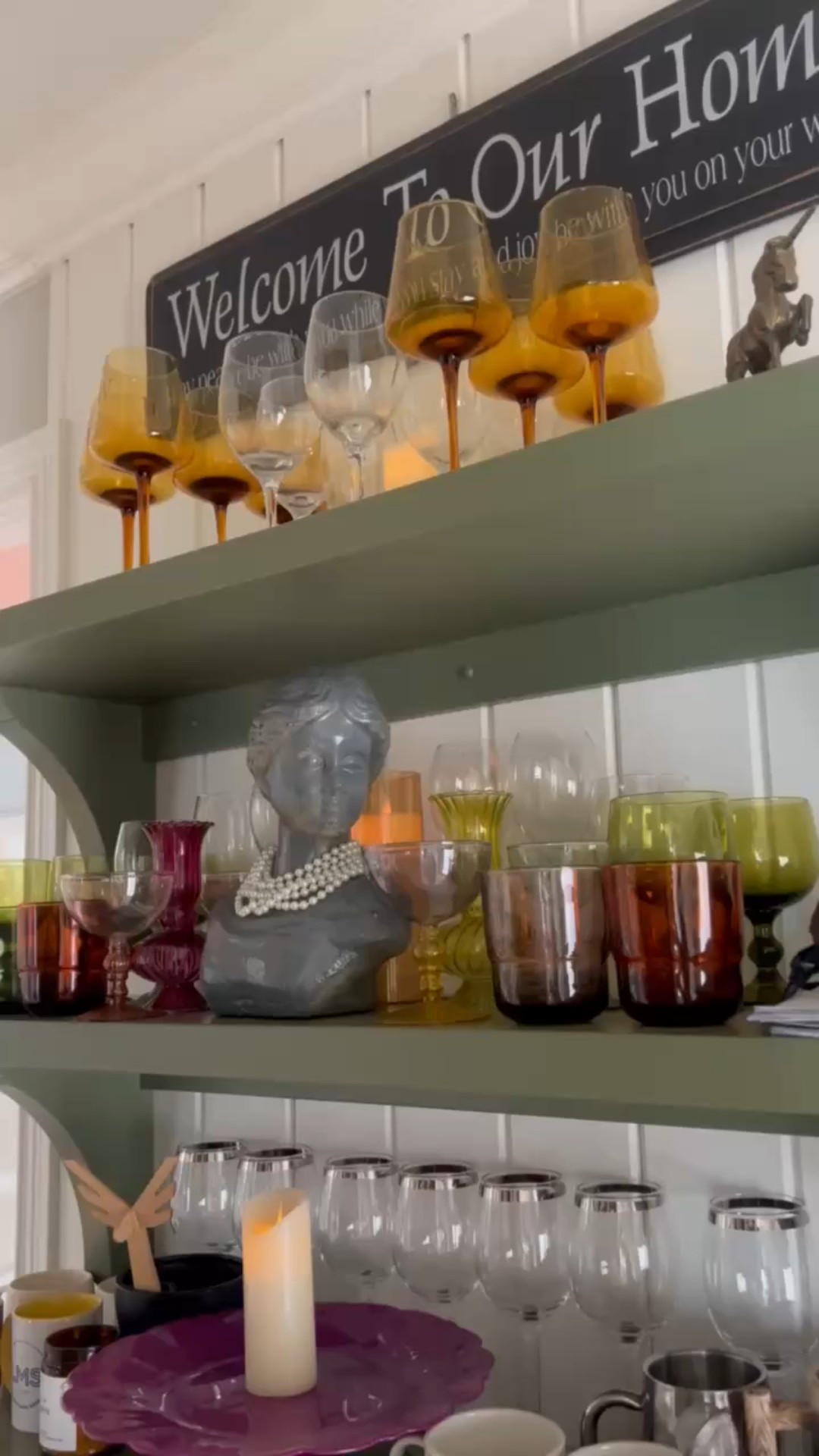 A peek at one of my favorite little corners in the house — shelves full of color, character, and just the right amount of sparkle ✨💜 I never met a vintage glass I didn’t love, and these jewel-toned beauties bring me so much joy. Add in my collection of monogrammed mugs, a bust draped in pearls (because why not?), and a purple cakestand that’s far too pretty to keep in a cabinet… and this shelf just sings with personality.

colorful kitchen shelf decor, vintage glassware display, eclectic home style, maximalist shelf styling, monogram mug collection, bust decor ideas, pearls as home decor, purple cakestand display, vibrant shelf inspiration, open shelving ideas, kitchen shelf styling tips, bold home accessories, unique kitchen corner, joyful home styling, layered home decor

 

 

#LTKHome #LTKFindsUnder100 #LTKStyleTip