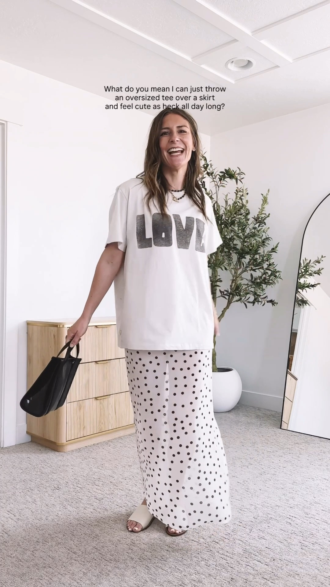 Proof that easy and cute are not opposites. I threw an oversized LOVE graphic tee over a flowy polka dot maxi skirt and styled it with a structured black tote and simple white slide sandals. It is the kind of outfit you can put on in seconds and feel put together in all day long, comfortable enough for real life but cute enough to feel like yourself.

#LTKootd #LTKgrwm #LTKmomlife