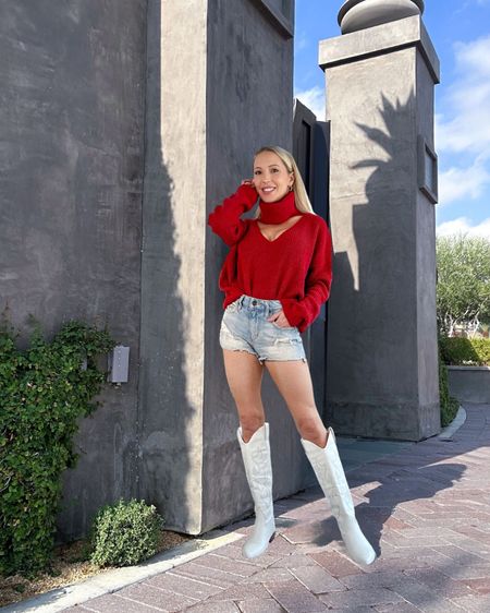 Transitional summer to fall outfit inspo: denim cut off shorts, white cowboy boots and a red roll neck sweater with cut outs to make it sexier than you basic sweatshirt. White knee high boots are under $50 and come in more colors.

#LTKshoecrush #LTKstyletip #LTKSeasonal