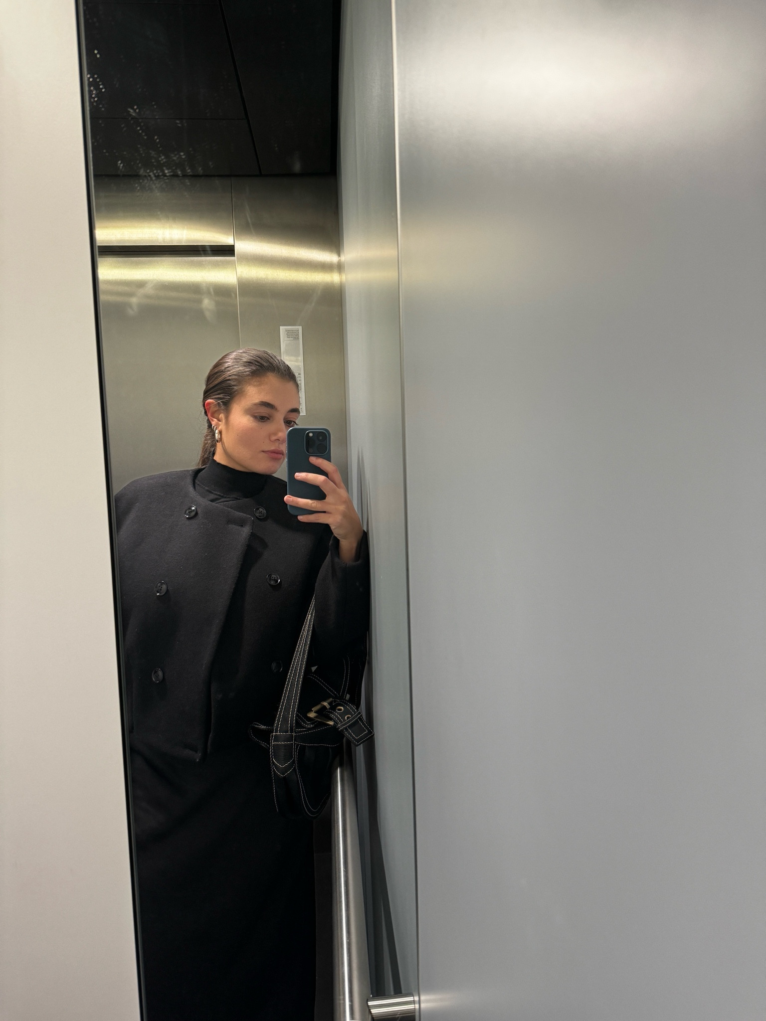 outfit inspiration, winter style, all black outfit, Arket, wool pea coat, Uniqlo, ribbed turtleneck jumper, bottega Veneta, Jodie leather handbag, Vestiare Collective, & Other stories, A line midi skirt, black skirt, small chunky hoop silver earrings, COS, Nederland.

#LTKstyletip #LTKSeasonal #LTKeurope