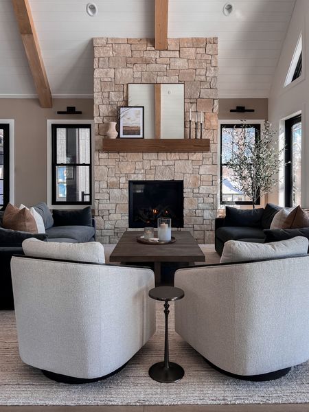 Lake home with a fireplace focal point. Mantle styling, velvet sofa, dark sofa, Arhaus, swivel chairs, pottery barn, coffee table decor 

#LTKstyletip #LTKSeasonal #LTKhome