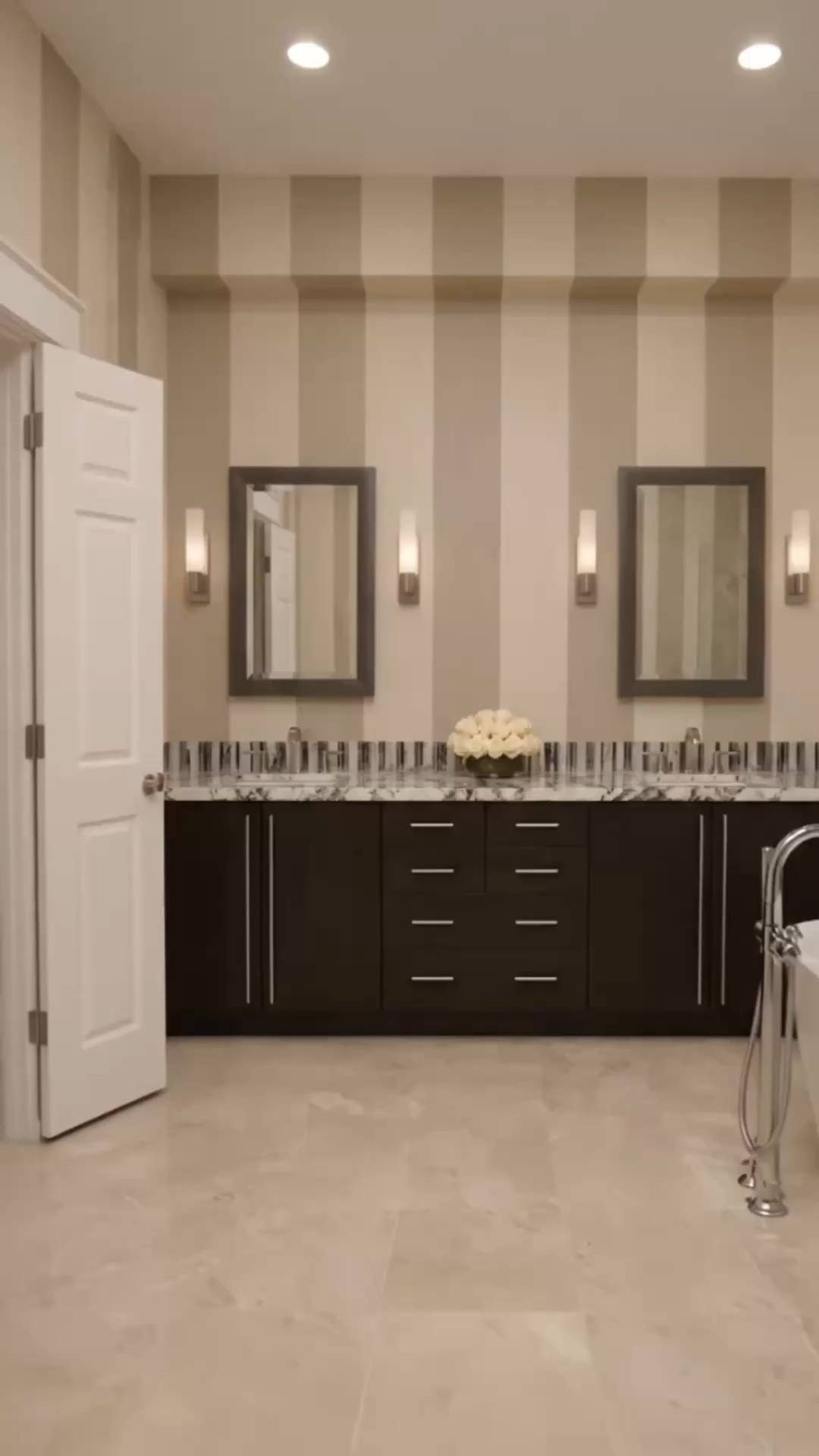 End-of-day retreat, but make it elevated ✨

A well-designed primary bath should feel like your own private reset button. I still love the clean architectural lines in this one—sleek slab-style cabinetry, generous drawer storage (because beautiful and functional matters), dramatic quartzite countertops, and that striped niche detail that adds just enough tailored personality without overwhelming the space.

Finished with soft cream roses for that quiet luxury moment 🤍

If you're planning a bathroom refresh, I’ll link similar vanities, lighting, mirrors, and styling pieces.

#primarybathroom #masterbathroom #bathroomdesign #bathroomremodel #customvanity #slabcabinet #quartzitecountertop #interiordesign #luxurybathroom #doublevanity #bathroominspiration #modernclassic #quietluxury #homedesign #vanitylighting

#LTKdayinmylife #LTKHome