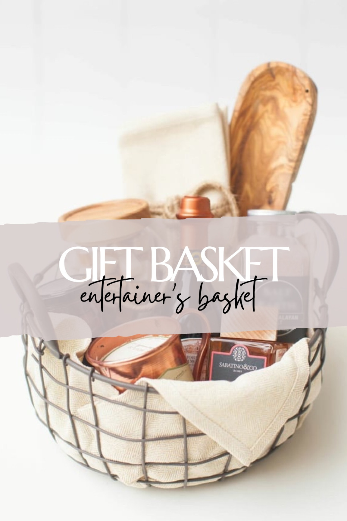 Gift basket idea for the entertainer | wire basket, appetizer tray set, aged balsamic vinegar, Moscow mule glass candle, pink Himalayan sea salts, jarred caramels, kitchen linens  — see all other basket sets on thesarahstories.com ✨ 

#LTKHoliday #LTKGiftGuide #LTKSeasonal