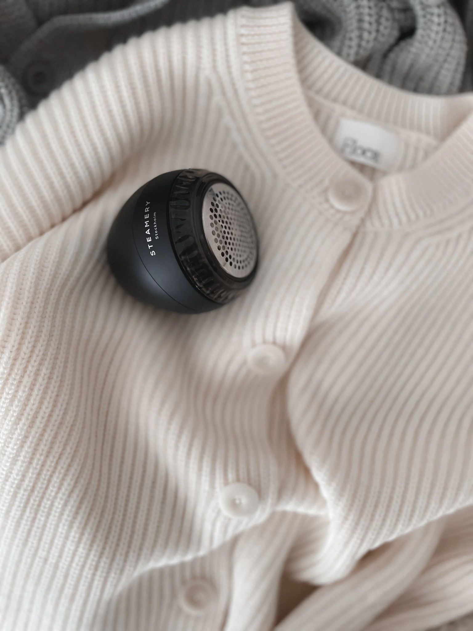 A  steamer, a fabric shaver/wool comb, and a gentle hand-wash detergent