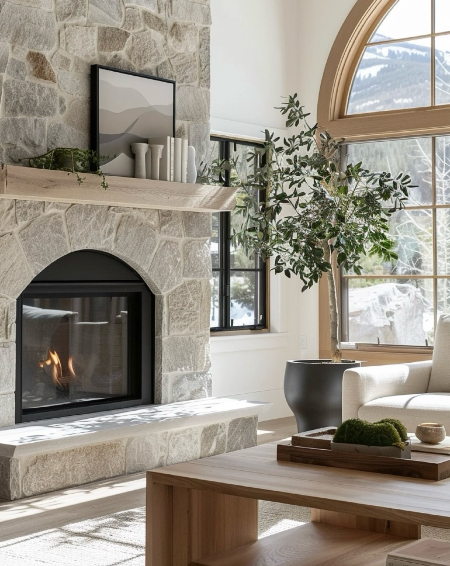 Stone + wood + natural light= breathing views 🫶🏼 Loving this organic modern living room. |Ai design by Ranger Home NW| coffee table, arched window, stone fireplace, planter, neutral decor

#LTKHome