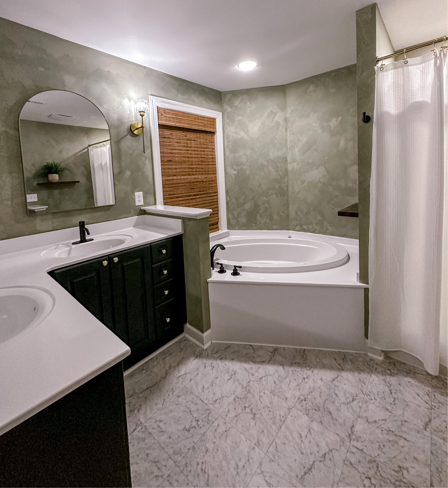 #primarybathroom #diybathroom #limewashwalls #blackcabinets #bathroominspo #archmirror #romanshades #wallsconce 

#LTKhome