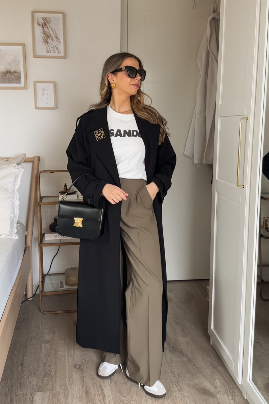 Full video on my TikTok: @nathalievdlu 
7 days of early spring outfits 4/7 🖤

Black trenchcoat | NA-KD trenchcoat | Zara trousers | khaki trousers | wide leg trousers | Adidas Samba | flat trainers | Jil Sander t-shirt | basic tee | Loewe brooch | golden details | Gucci sunglasses | black sunglasses | designer sunglasses | black bag | Kassandre Paris bag | designer bag | workwear | capsule wardrobe | spring outfit | spring fashion | trenchcoat season