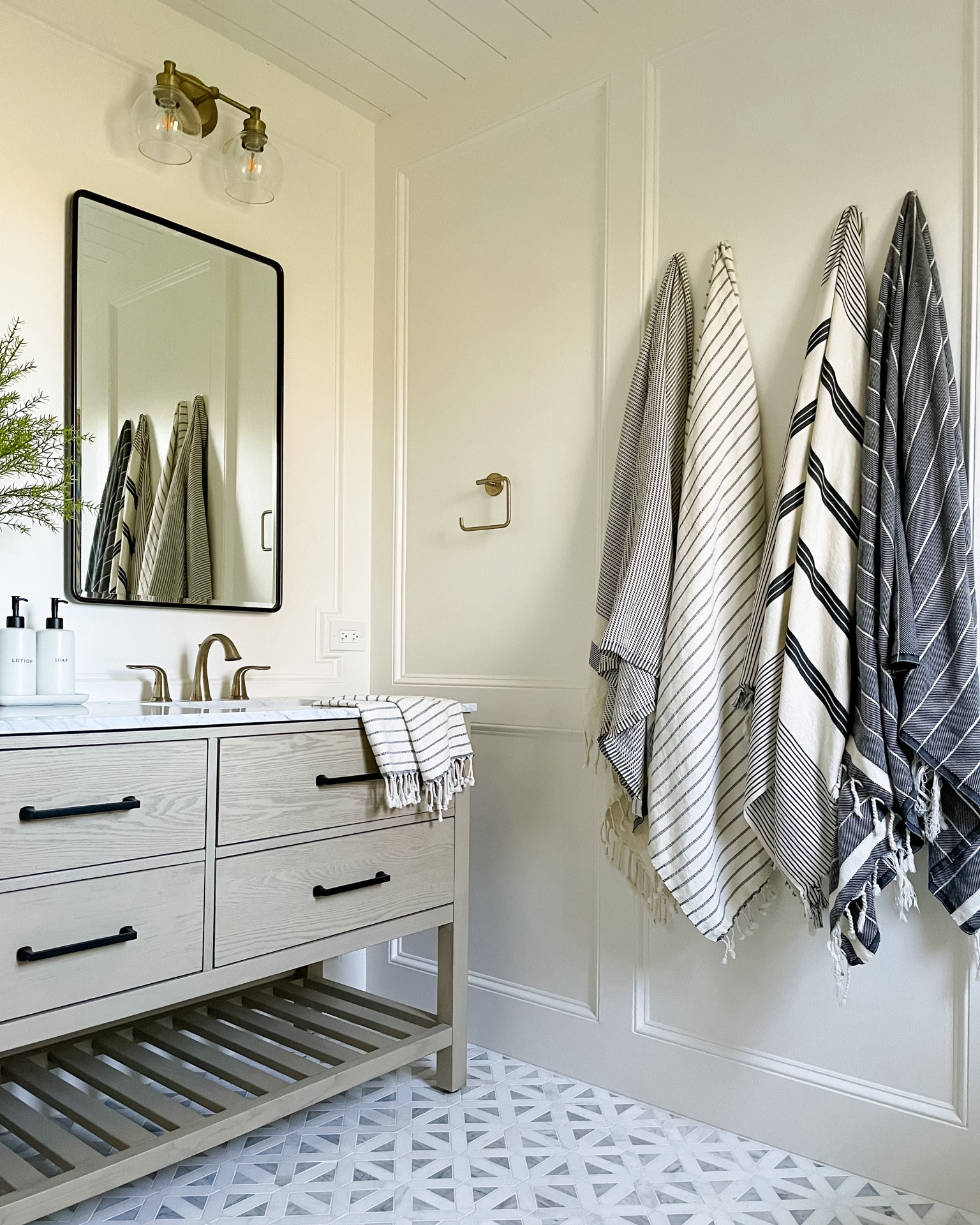 Bathroom design. Turkish towels. Marble floor tile. Drawer handles. Towel holder. Bathroom faucet. Recessed medicine cabinet. Bathroom mirror. Soap and lotion dispenser. Bathroom vanity. Double light sconce  

#LTKCyberWeek #LTKhome