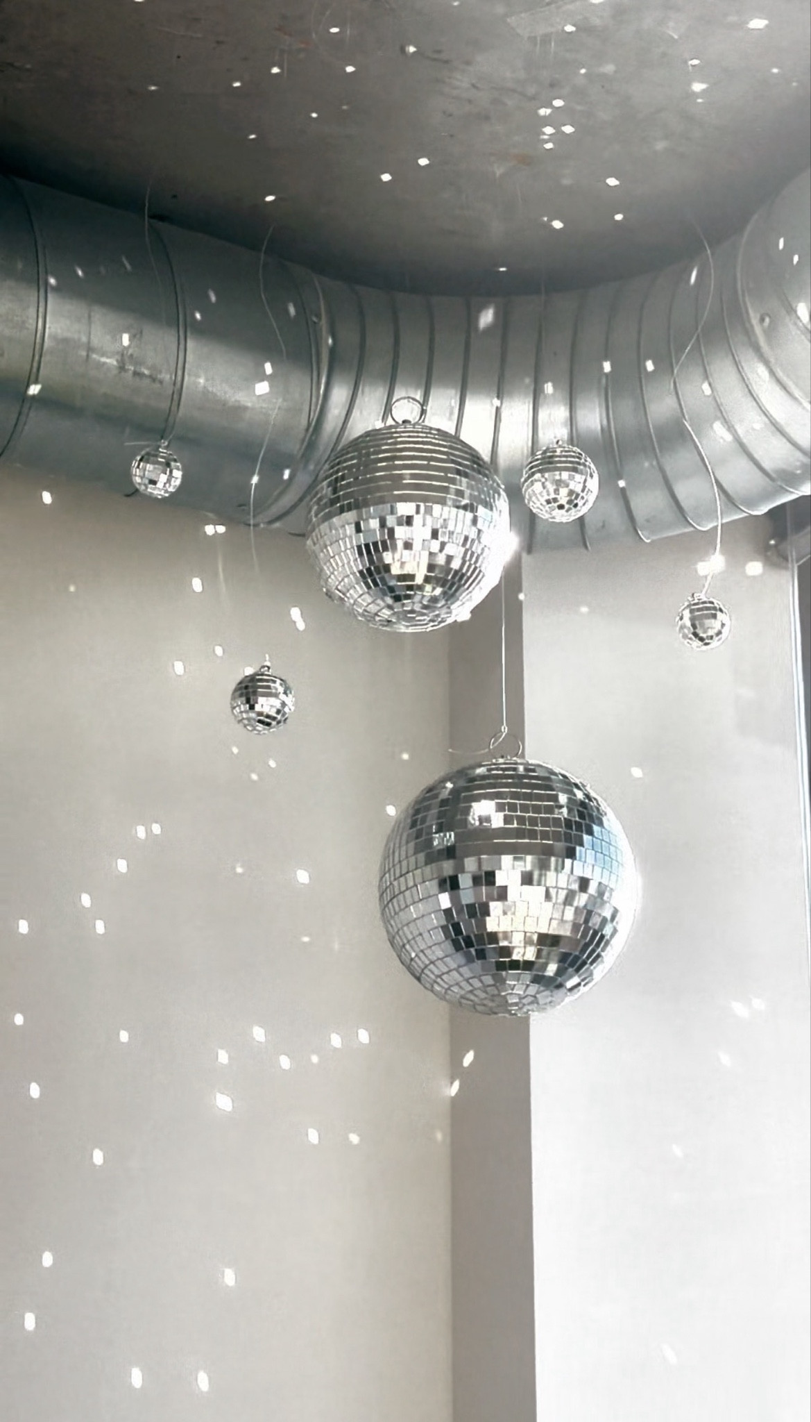 Disco balls make everything better. Disco ball decor and party decorations are a whole personality.

For this installation I used 6 different disco balls and hung them from my ceiling! I love how the light reflects off of them in the morning at sunrise and at sunset at night. The reflections dance on my walls all day long and it makes me so happy ☺️✨🪩

#LTKspring #LTKHome #LTKWedding