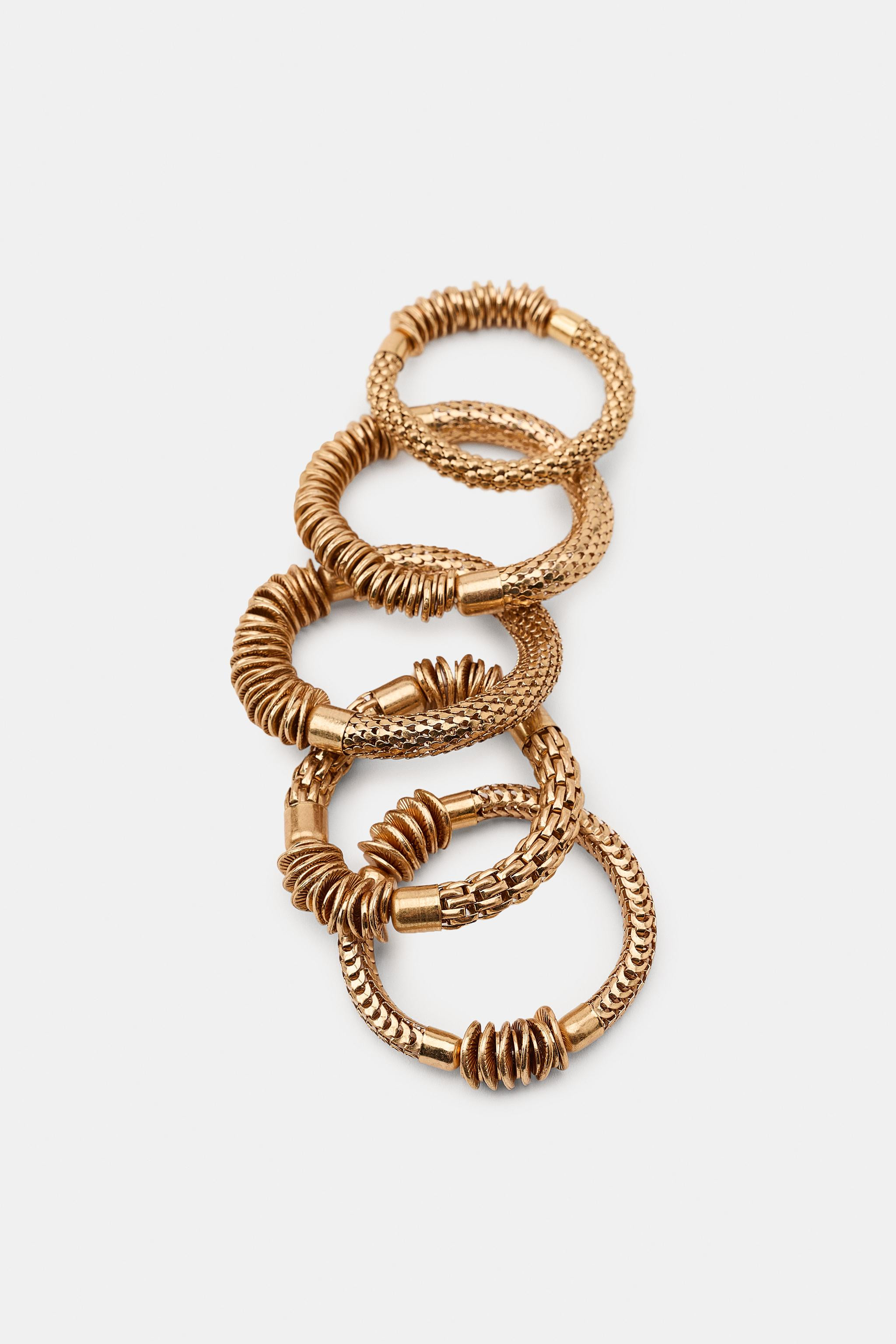 Pack of five elastic bracelets with metallic pieces in various shapes and sizes. | Zara US