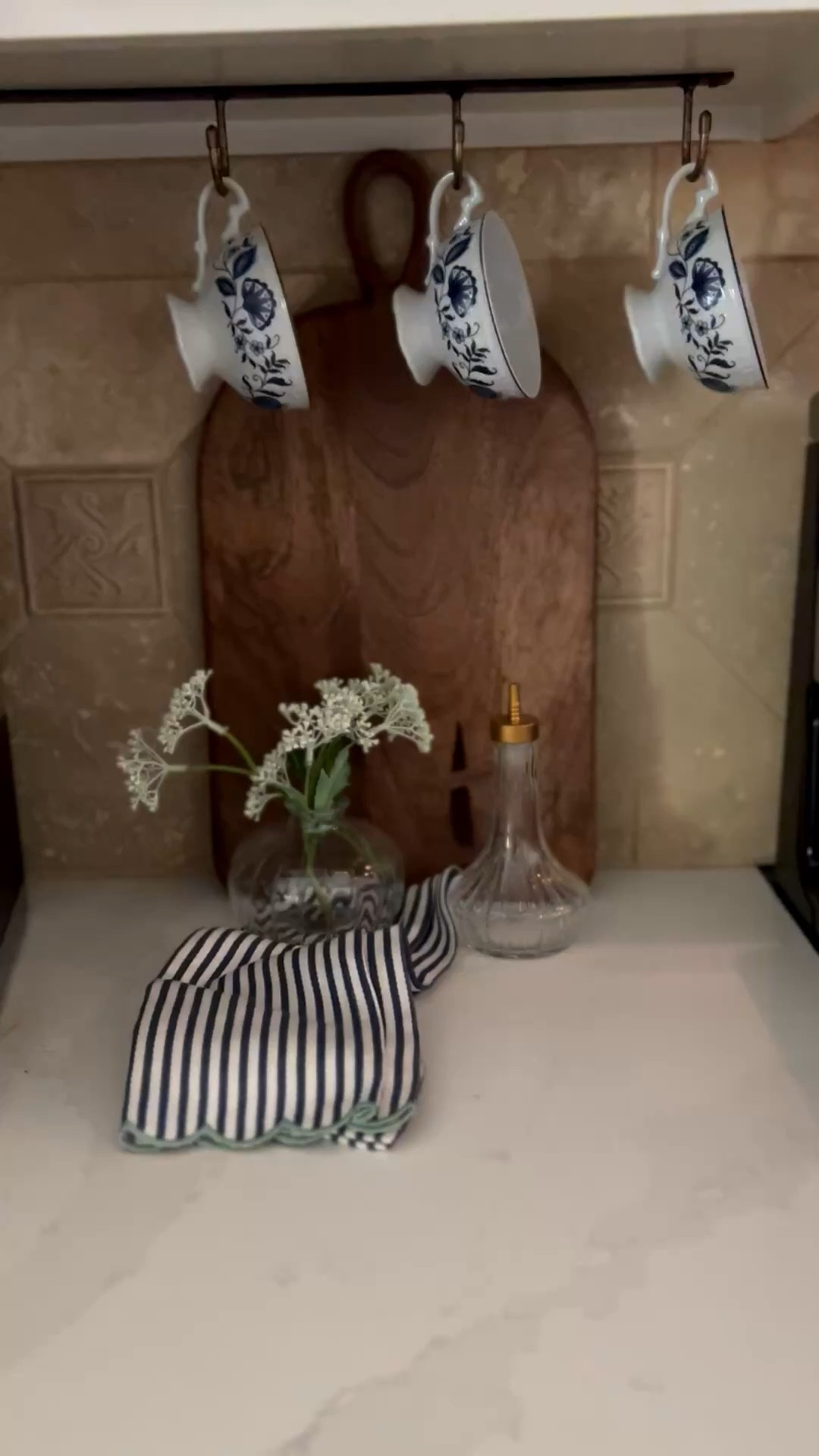 Blue and white kitchen 
Wood kitchen board 
Striped tea towel 
Glass dispenser 

#LTKHome #LTKSeasonal #LTKSaleAlert