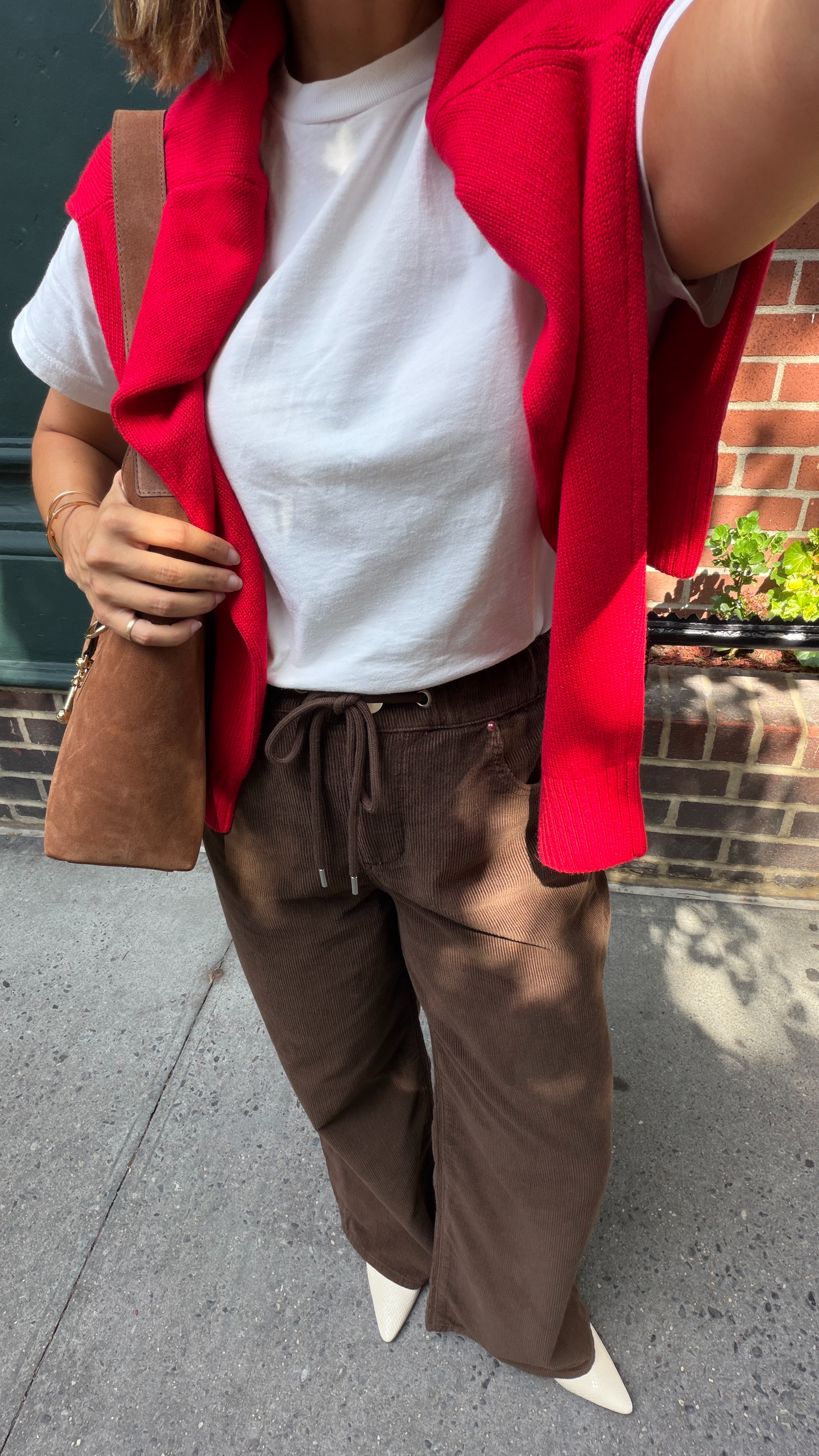 An easy fall color combination I’ll be repeating: chocolate brown with a pop of bright red. These relaxed corduroy pants feel comfortable but still elevated with a classic white tee, pointed-toe flats, and an oversized suede bag. Add a sweater over your shoulders now, then wear it as an extra layer once the temperatures drop. 

 #LTKootd #LTKSeasonal