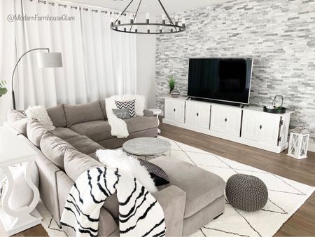 Neutral area rugs white rug at Modern Farmhouse Glam. 
Couch sofa love seat grey gray media console table livingroom furniture greatroom family room marble coffee table throw blanket chandelier lighting ottoman lamp accent wall stone home decor decorations 

#LTKhome #LTKsalealert