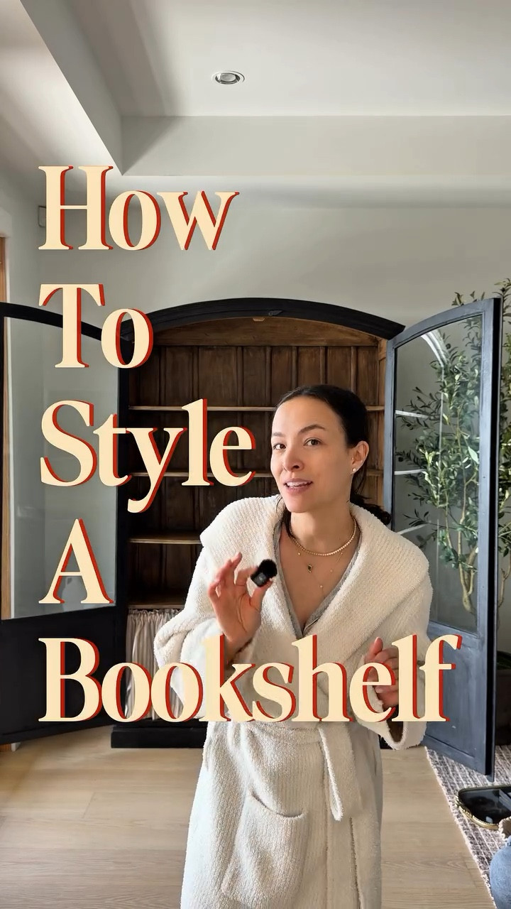 Shelf styling made easy-ish. 

Truthfully I think shelves are one of the hardest things to style so first and foremost, give yourself some grace. 

Adding a few extra tidbits for you: 

- start with a colour palette - pick 2-3 colours and repeat them. It’s what makes everything feel intentional instead of random

- go big, not many - a few oversized pieces beat a bunch of small ones every time. too many little
items = visual clutter

- vary your heights - mix tall, medium, and short. stack books horizontally to create a riser for smaller pieces

- layer in texture - wood, glass, woven, ceramic. the mix is what makes it look expensive

- lean art at the back - propping a frame behind your accessories adds depth without any extra effort

- edit ruthlessly - if it looks just as good with less, go with less. breathing room is part of the design. 

Also, the intro of this reel adapted from the ultra talented @lillianavazquez - if you don’t follow her for fashion advice, what are you doing?!