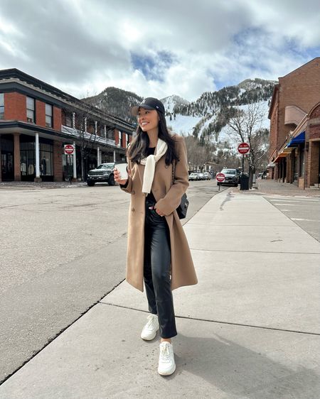 Kat Jamieson wears a double breasted camel coat in Aspen with faux leather pants and sneakers. Winter outfit, casual style, what to wear in Aspen. 

#LTKstyletip #LTKSeasonal #LTKfindsunder50