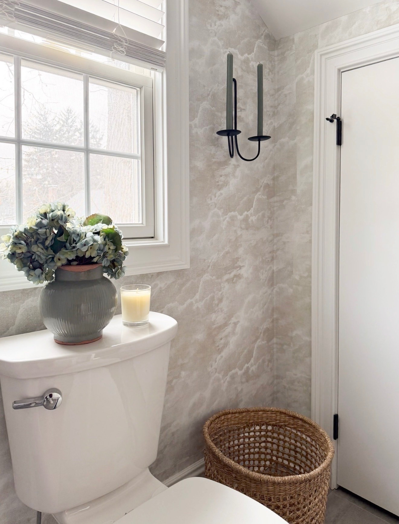 Small details can completely change the feeling of a space, and I’ve been loving adding soft layered touches throughout our home lately. From the textured wallpaper to the woven basket and hydrangeas, this little bathroom corner feels so much warmer and more collected with just a few simple additions. The candle sconces add the prettiest cozy glow in the evenings too.

bathroom decor ideas, powder bathroom styling, woven basket decor, hydrangea arrangement, cozy bathroom inspiration, traditional home decor, wallpaper bathroom ideas, candle wall sconces, neutral bathroom decor, elevated everyday spaces, Girl on the Hudson

#LTKHome #LTKSeasonal