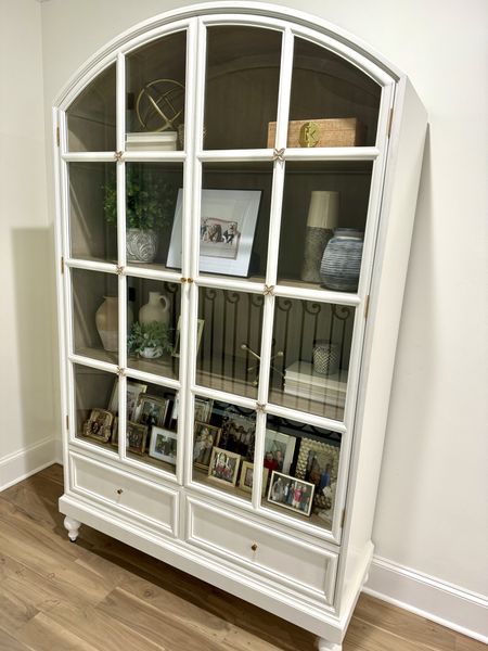 Arched Cabinet with glass doors. 

I was smitten with this piece and it was the perfect addition to our upstairs hallway. It’s a beautiful soft cream color and excellent quality. 

Mix and match pieces of decor with texture and personal photos. 

#everypiecefits

Home decor
Home furniture
Home furnishings 
Home decorations
Decor
Cabinet
Hutch

#LTKfamily #LTKhome