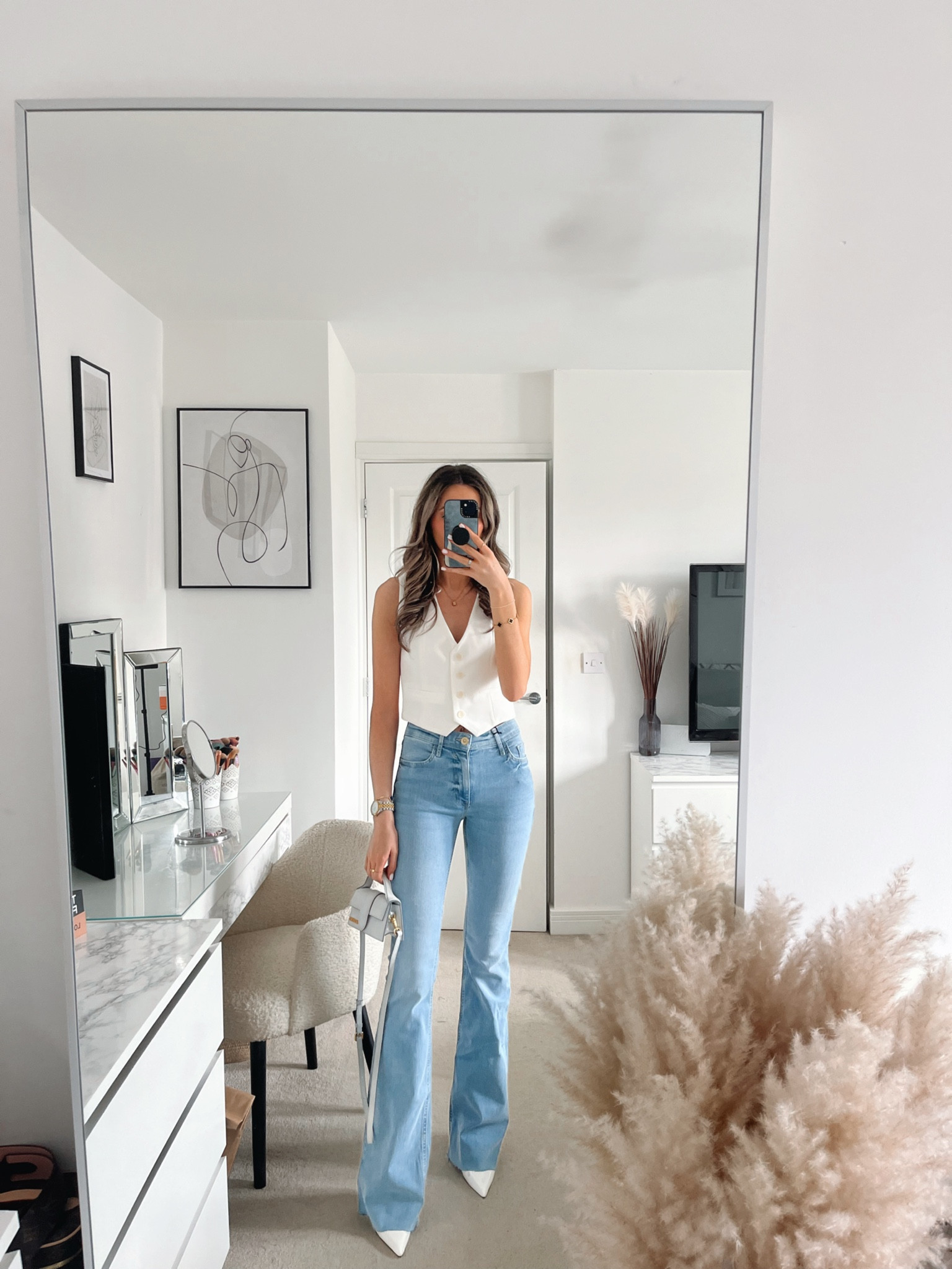 White waistcoat, blue flare denim jeans, white heels. Chic outfit. 

#LTKstyletip #LTKSeasonal #LTKeurope