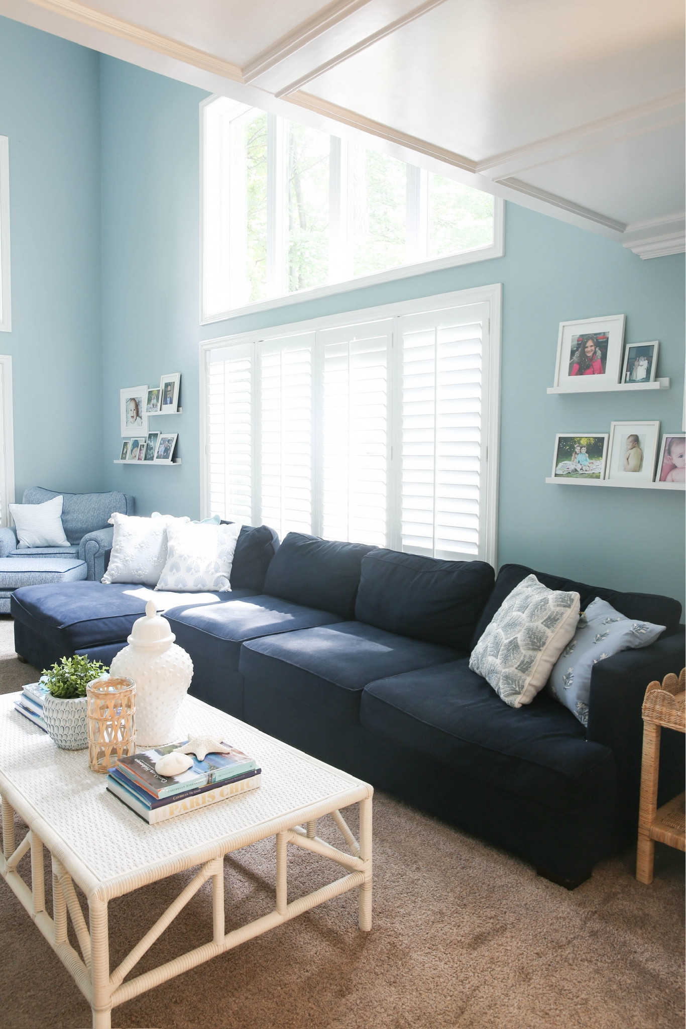 Coastal family room style! Includes blue sofa, white coffee table, coastal coffee table books, ginger jar, scalloped rattan side table, blue pillow cover
12/3

#LTKHome #LTKStyleTip