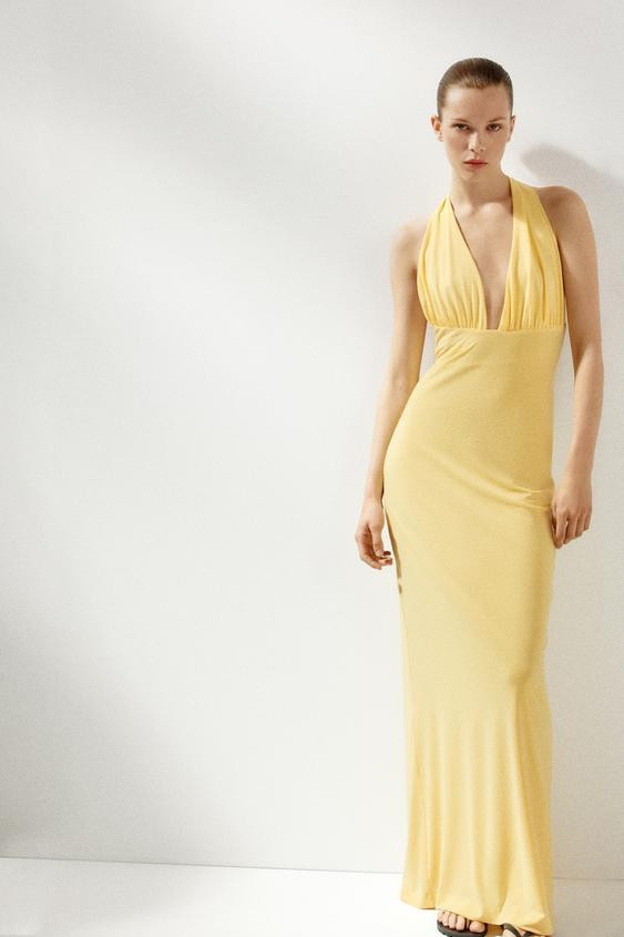 Long dress made in knit fabric. Halter neck with tie and plunging neckline. Inner lining. Back hi... | Zara US