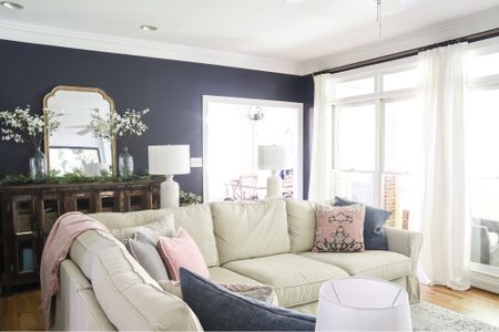 My springtime navy living room decor features dogwood branches and pink and blue throw pillows..

#LTKHome