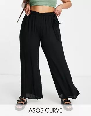 ASOS DESIGN Curve tie waist palazzo beach pants in black | ASOS (Global)