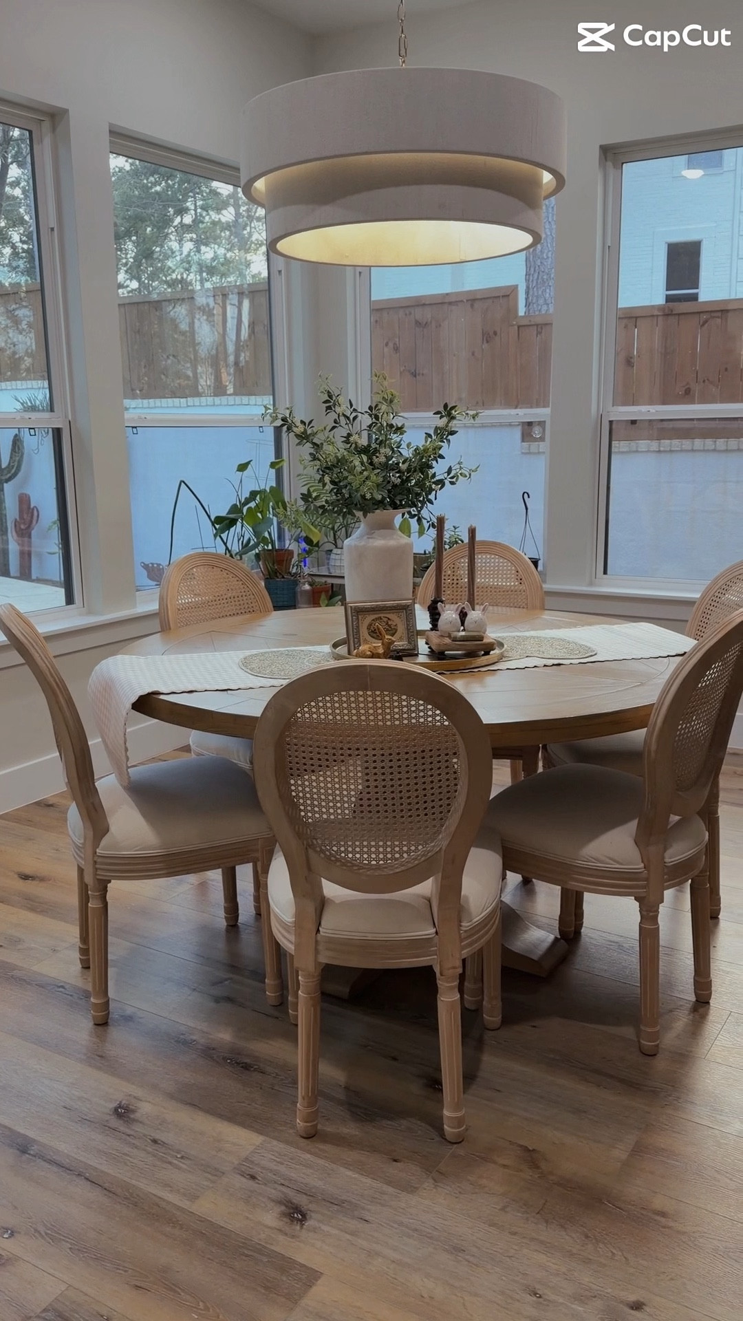 Elevated neutral dining space featuring a round wood pedestal table with a subtle plank detail and matching cane back dining chairs
Ilove
how the light wood tones keep the space feeling warm and organic while the woven rattan texture adds that timeless
European-inspired charm.
#LTKOver40 #LTKHome
#LTKSeasonal

#LTKHome

#LTKdayinmylife #LTKHome #LTKmomlife