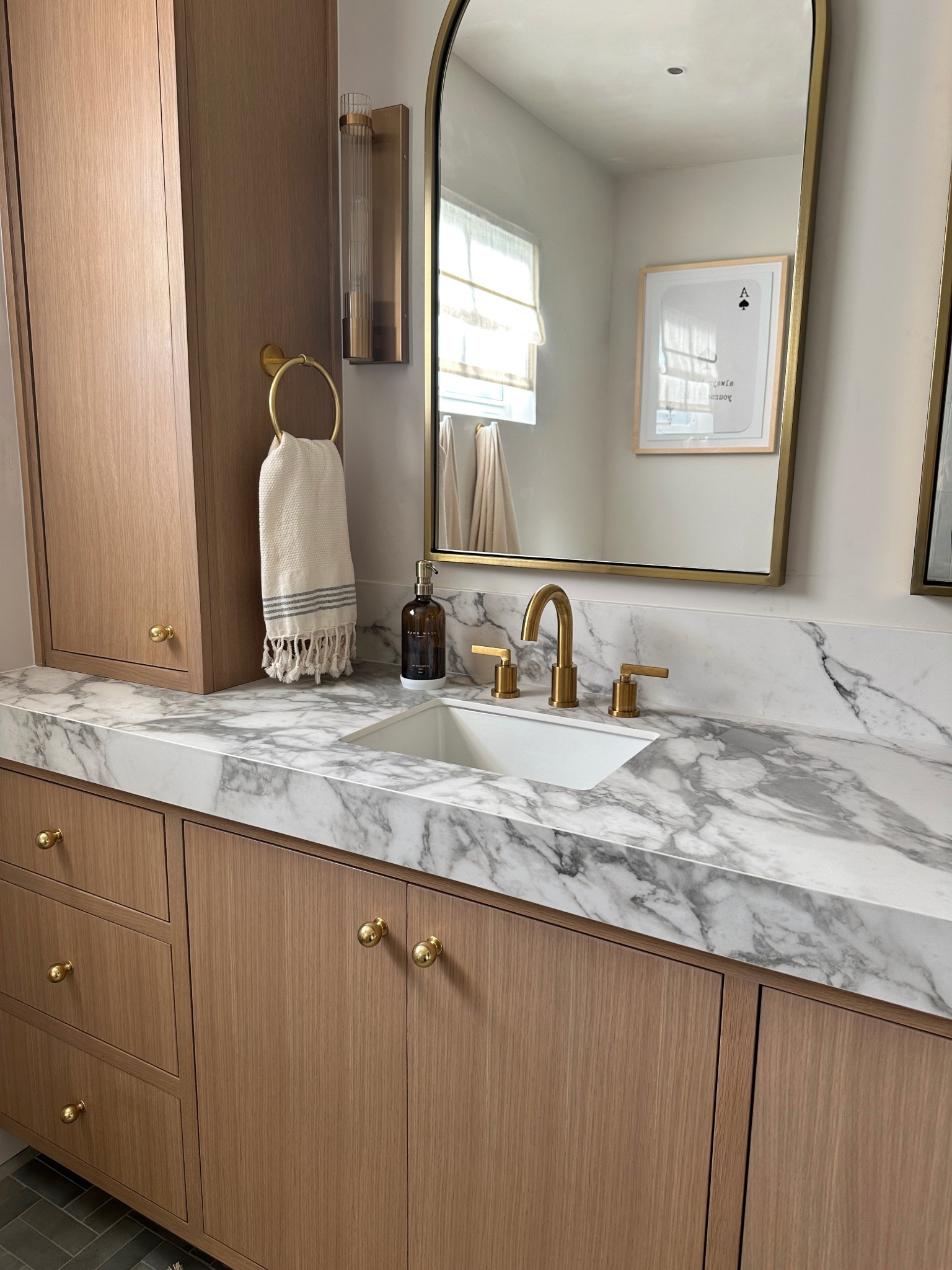 Warm, classic, yet edgy brass and details for this master bathroom. Love an arched mirror  