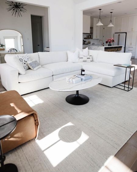 Fresh, clean living room! Love an all white look with pop of color. Sectional is from Arhaus, which we have loved for years! Coffee table from Crate & Barrel and has been a staple for our living room. Love the sleek design of the lighter top and black base!  

#LTKhome #LTKstyletip