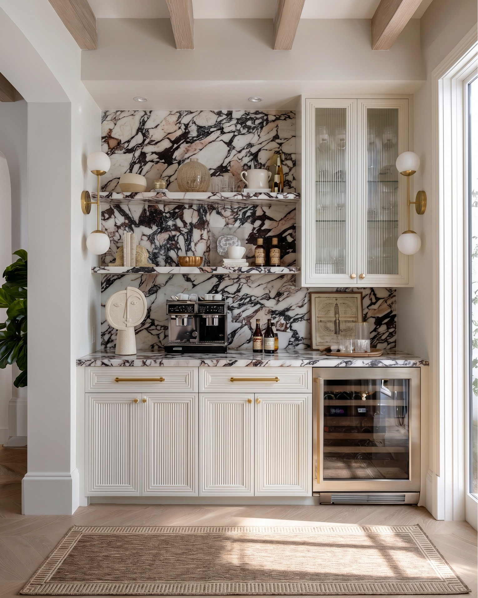 Shop the look:
• Fluted cream built-in cabinetry
• Brass cabinet hardware (pulls + knobs)
• Glass-front upper cabinet doors (reeded / ribbed glass)
• Brass dual globe wall sconces (white milk glass)
• Built-in wine fridge (glass door, brass trim)
• Espresso machine / built-in coffee station
• Decorative ceramic face sculpture
• Neutral ceramic bowls
• White ceramic pitcher
• Amber glass bottles
• Framed vintage artwork
• Decorative wood tray
• Brass bowl / catchall
• Sculptural woven vase
• Neutral decorative books
• Large woven or textured runner rug (taupe / beige)
• Light oak ceiling beams
• Light wood console table (minimal modern design)
• Upholstered round stools / vanity stools
• Neutral floral wallpaper (large-scale botanical print)
• Oversized abstract wall art (black frame)
• Brass double globe sconces
• Ceramic table lamp (neutral textured base)
• Gold sculptural ring decor
• Large rope detail ceramic vases
• Vintage-inspired neutral hallway runner
• Decorative wood bowls
• Ceramic decor accents
• Cream boucle accent chair
• Arched black-framed window
• Light gray upholstered wingback bed
• White bedding set (duvet + sheets)
• Chunky knit throw blanket (cream)
• Neutral accent pillows (textured + patterned)
• Upholstered bedroom bench (cream with brass legs)
• Light wood nightstands (3-drawer)
• Pleated table lamp (neutral ceramic base)
• Large glass vase with greenery / dried florals
• Ornate gold full-length mirrors
• Brass double globe wall sconces
• Large abstract artwork above bed
• White globe pendant light
• Vintage-inspired area rug (gray / beige)
• Light wood ceiling beams
• Soft linen curtains (cream)
• Herringbone hardwood flooring
• Small ceramic vase with dried florals
• Decorative bedside styling
• Neutral ceramic lamp
• Gold framed mirrors
• Minimal layered pillows
• Luxury hotel-style white duvet

#LTKsale #LTKhome