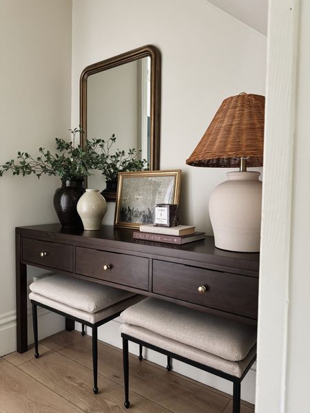 Entryway reveal, this was an awkward space underneath the stairs that has been bare ever since we moved in. I wanted to update it without using any power tools or building anything, I found this solid wood consult table that fit perfectly. I decided to leave off the hardware and add my owntable lamp from Wayfair, the most gorgeous brass arched mirror from Wayfair brown vase from Mago, Amber, interiors, coffee table book, Studio, McGee from target Ottomans

#LTKhome #LTKstyletip #LTKsalealert