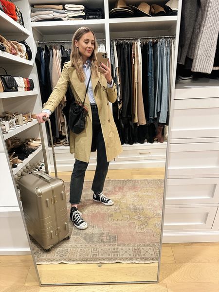 Fashion Jackson travel outfit, blue shirt use code FJBF20 (wearing a small) also comes in white! Black AGOLDE jeans, converse sneakers, trench coat (small) #fashionjackson #traveloutfit #jeans #sneakers 

#LTKtravel #LTKshoecrush #LTKunder100