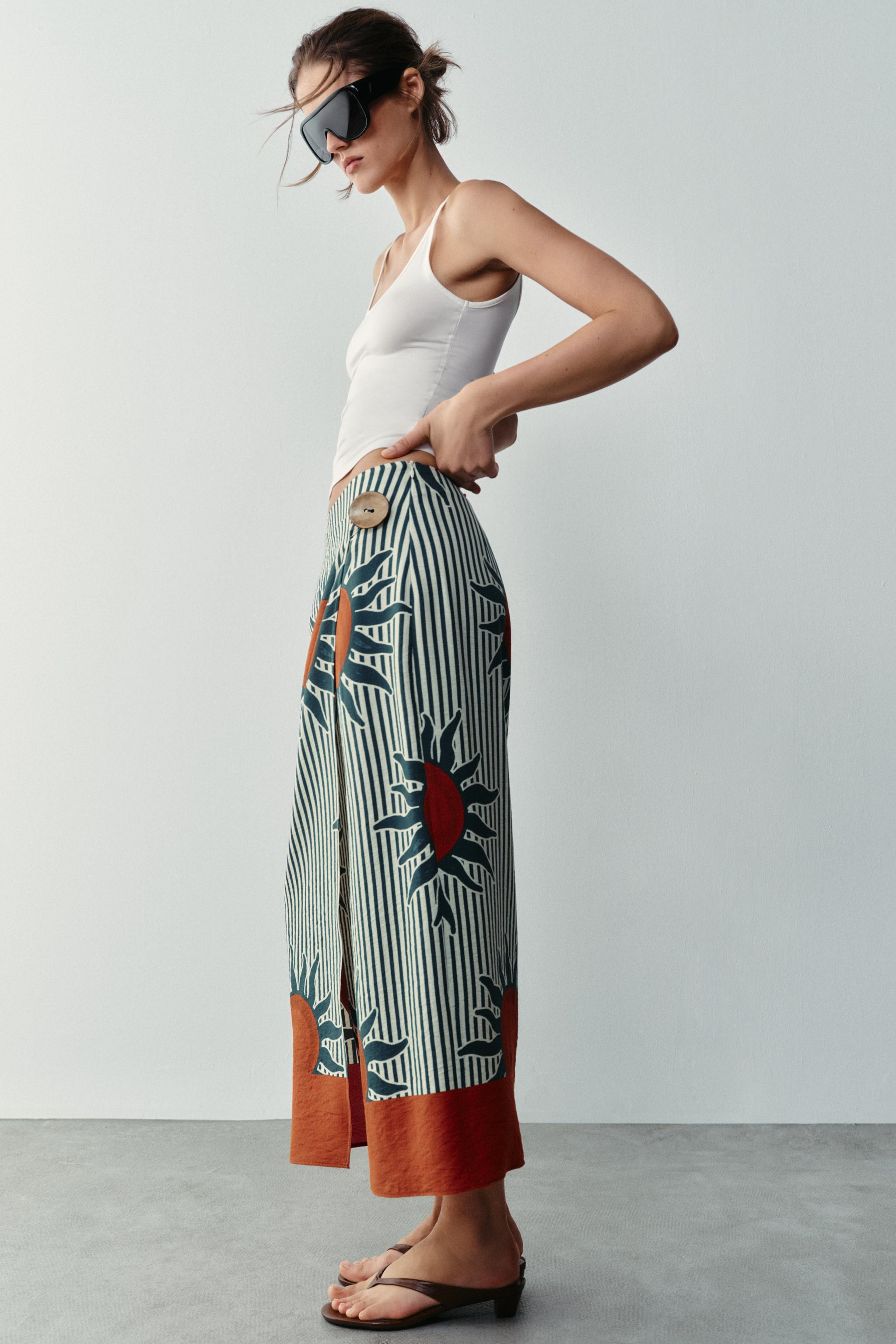 Sarong-style skirt with a wrap-front and faux button detail. Features a side zip fastening hidden... | Zara US