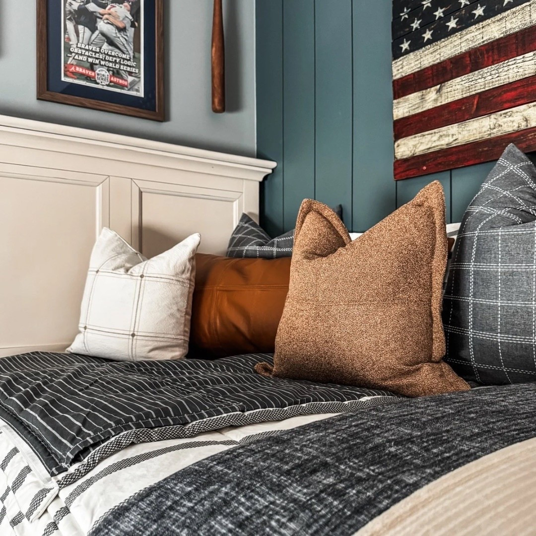 Classic Americana style 🇺🇸 This cozy setup features a crisp white bed frame dressed in striped bedding, layered blankets, and stacked accent pillows in plaid, leather, and warm tones. A wooden nightstand pairs perfectly with a brass wall sconce, while a bold American flag wall art makes a statement. Under-bed storage bins and a patterned rug add both function + style. ✨

Bedding by Beddy’s
Code EANES = 20% off 

Bedding Details: 
Chandler Beddy’s (Twin, Cotton, ZipBase)
Taylor Luxe Blanket 
On-the-go blanket tan grid 
Owen Luxe Leather XL Lumbar Pillow Cover
Lincoln Medium Pillow Cover
Monroe Medium Pillow Cover 
Lucas Euro Pillow Cover

#BedroomDesign #AllAmericanStyle #StripedBedding #ThrowBlankets #AccentPillows #WoodNightstand #BrassSconce #AmericanFlagArt #UnderBedStorage #PatternedRug #eanesinteriors


#LTKStyleTip #LTKOver40 #LTKHome