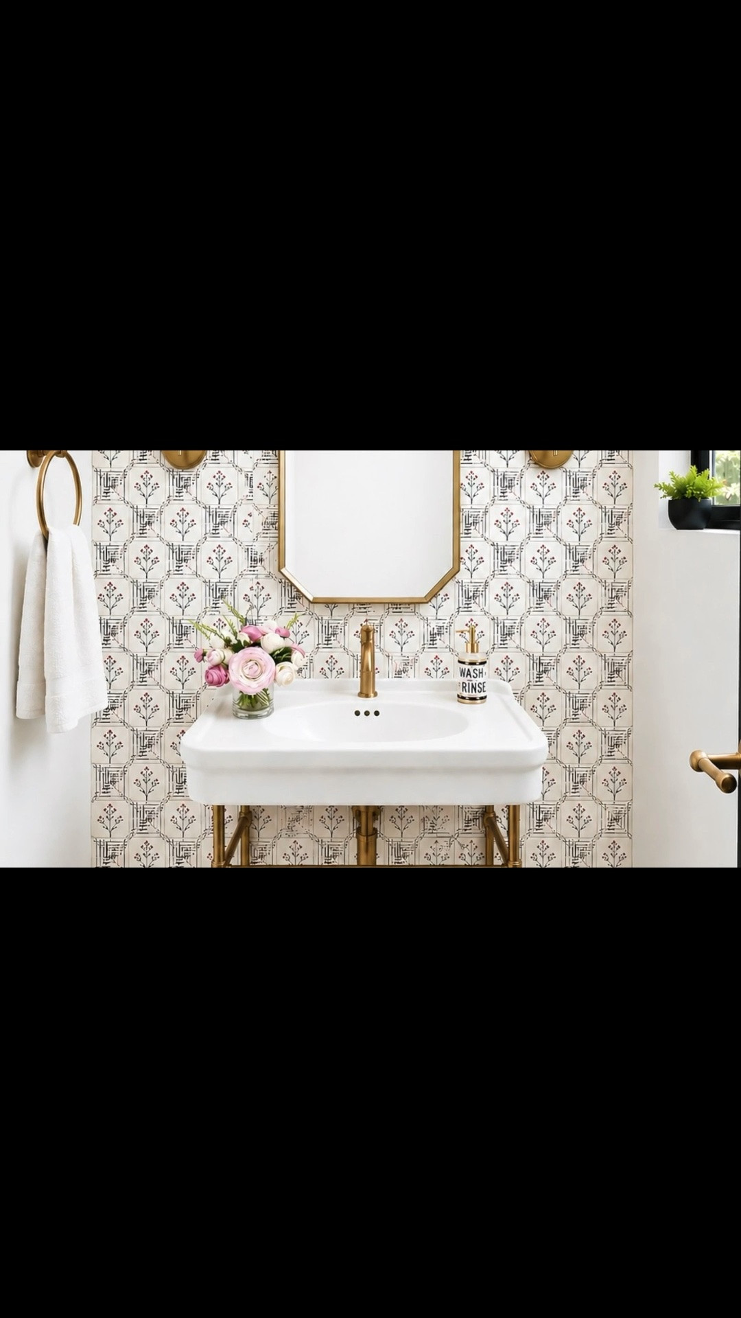 Imagine your guests stepping into this beautiful powder room in the morning—a modern, romantic space designed to feel welcoming and uplifting. The floral tile brings softness and personality, while the sleek brass console vanity adds an elegant architectural touch. Its open design keeps the room feeling light and spacious, while still providing a functional sink area for everyday use. A refined mirror, warm sconces, towel ring, soap dispenser, and flower arrangement complete the space with thoughtful beauty and function.

#PowderRoom #BathMirror #VanityMirror #ConsoleVanity #Washbasin #WallSconce #TowelRing #Tile #FloralTile #FlowerArrangement #SoapDispenser

#LTKdayinmylife #LTKHome #LTKSaleAlert