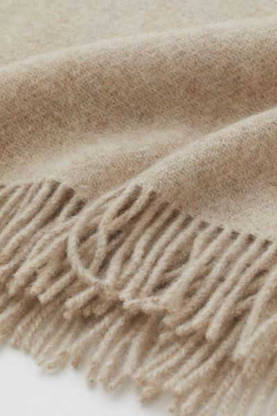 Premium Quality
	Blanket in a soft, undyed wool weave with fringes along the short sides. Undyed ... | H&M (UK, MY, IN, SG, PH, TW, HK)