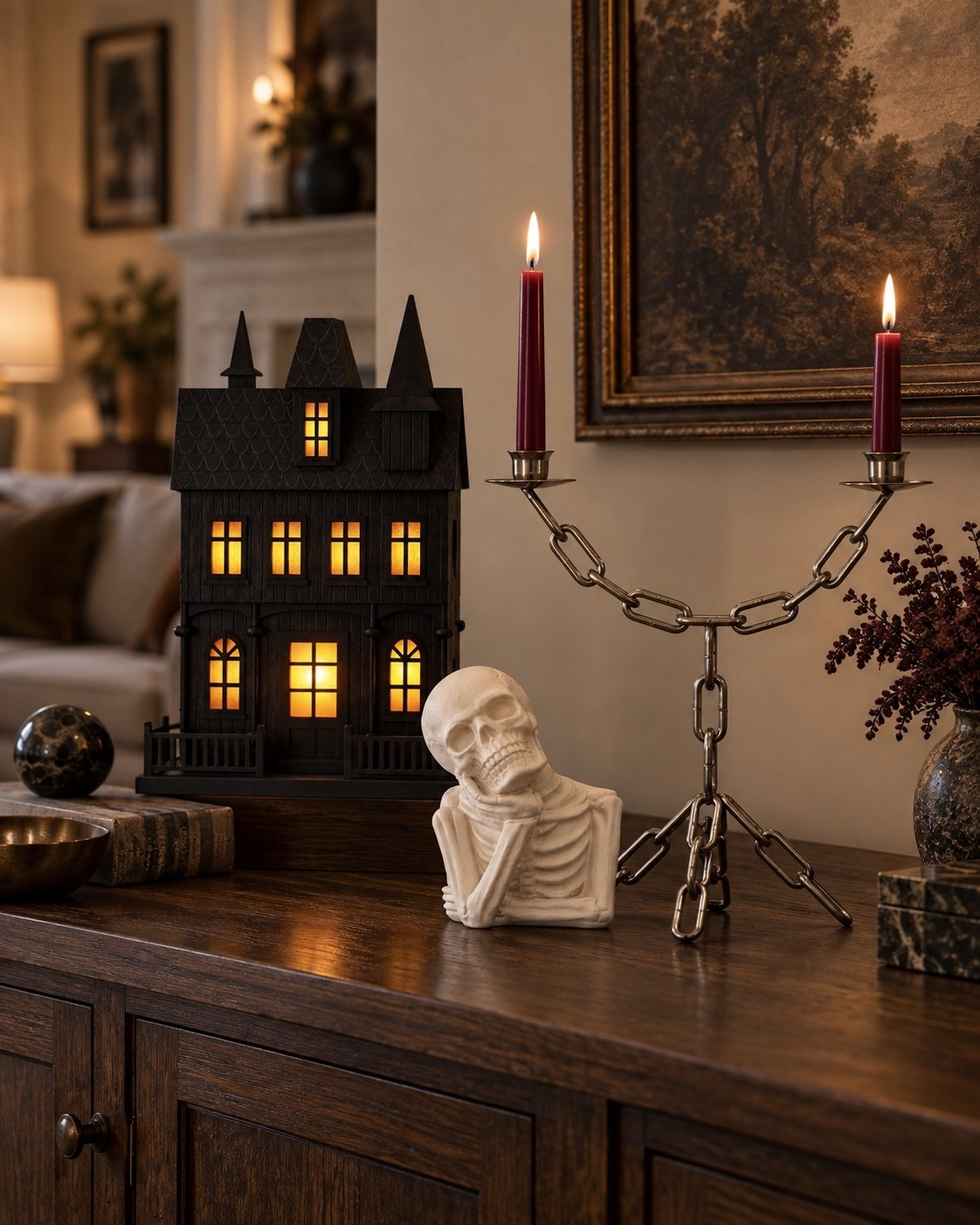 Halloween decor can be spooky without sacrificing your entire aesthetic. 🖤 A glowing haunted house, sculptural skeleton and chain candelabra bring in just enough Halloween while warm wood tones and vintage-inspired details keep everything feeling collected and elevated.

elevated Halloween decor, haunted house decor, skeleton decor, Halloween candelabra, moody Halloween decor, vintage Halloween decor, neutral Halloween decor, sophisticated Halloween decor, Halloween console styling, spooky home decor, Halloween living room, fall home decor

#LTKSeasonal #LTKHome #LTKSaleAlert