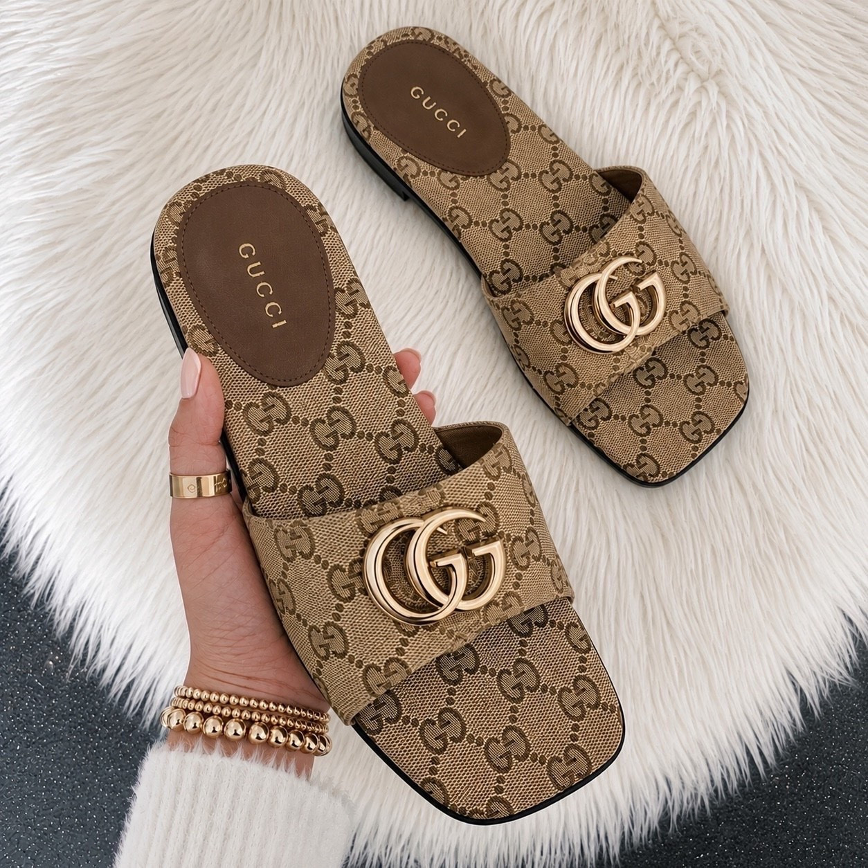 These Gucci Double G slides are the perfect mix of effortless luxury and everyday chic. The iconic GG canvas and gold Double G hardware make them such a timeless pair that instantly elevates any outfit, whether you’re dressing up denim or throwing them on with a summer dress. They’re comfortable, classic, and definitely a closet staple you’ll reach for again and again.

Sizing: I wear a US 8.5 and take a Gucci size 39.5 in these. They fit me perfectly, so I’d recommend ordering your usual Gucci size.