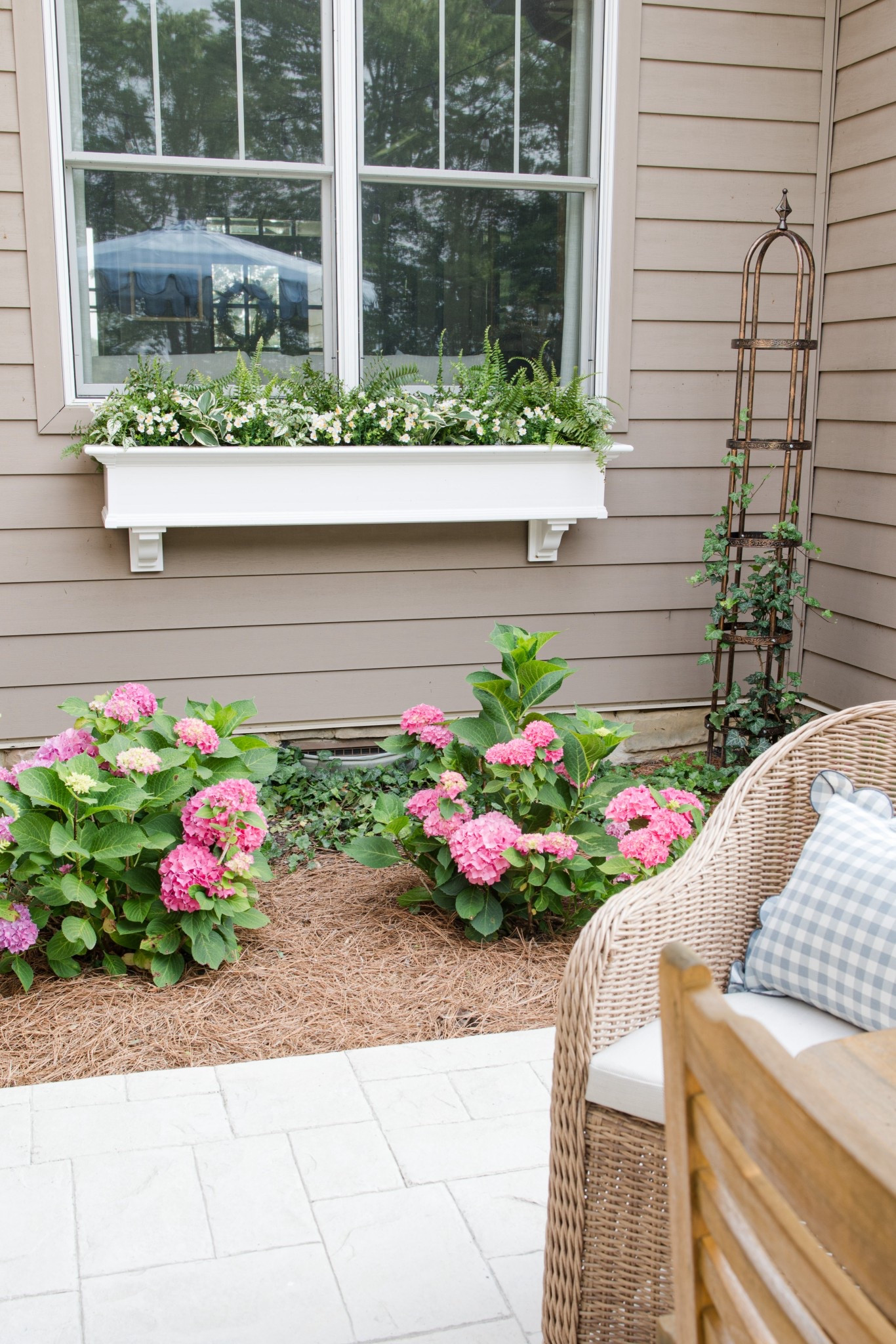Back patio with window box and hydrangeas with wicker chairs and patio umbrella 

#LTKSeasonal #LTKSummerEdit #LTKHome