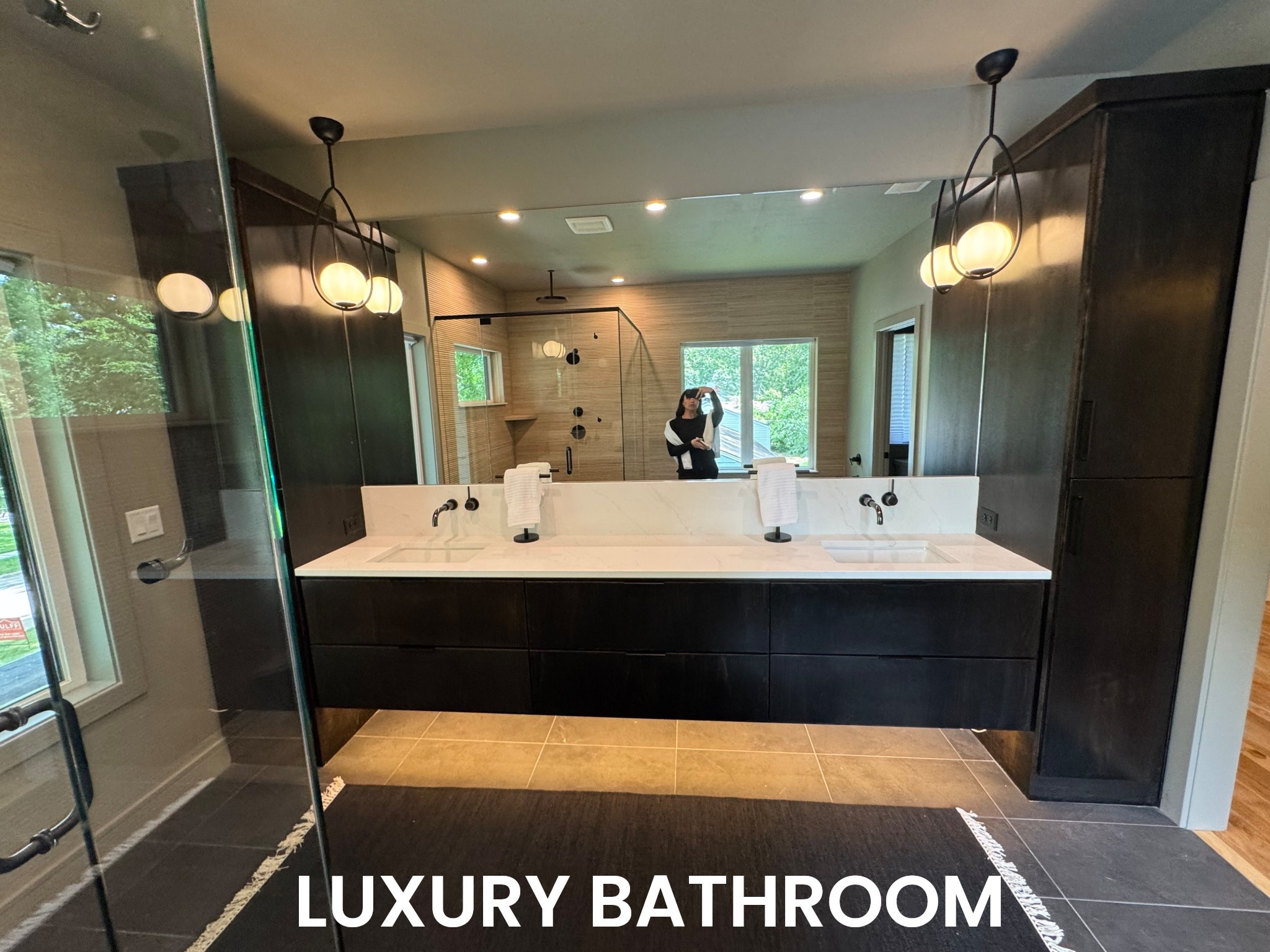 Modern bathroom goals, am I right?! We love the wall mount gunmetal faucets, the luxury pendant lighting, and a simple and elevated bathroom runner for this primary bath design. 

#LTKHome